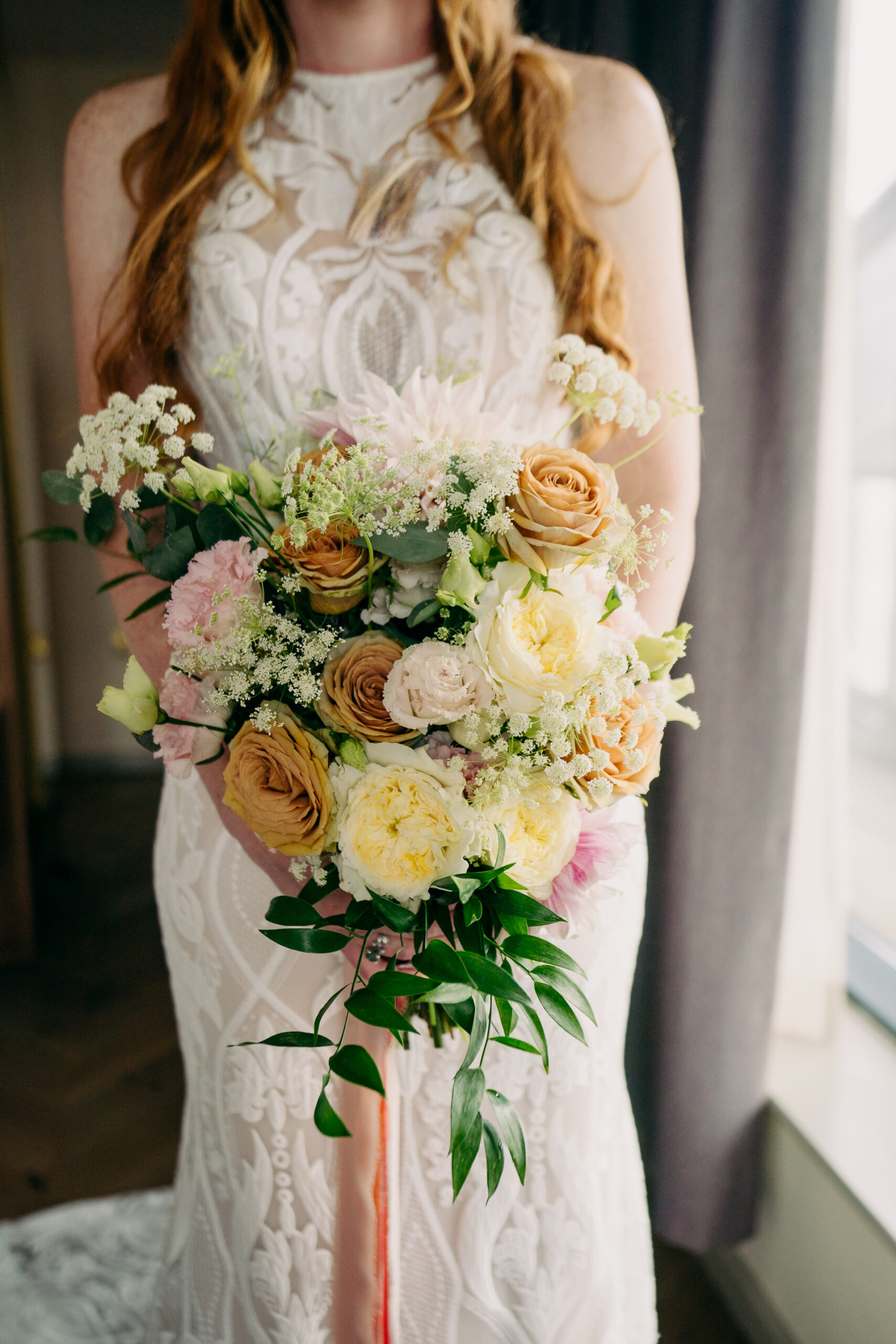 A woman wearing a white dress with flowers