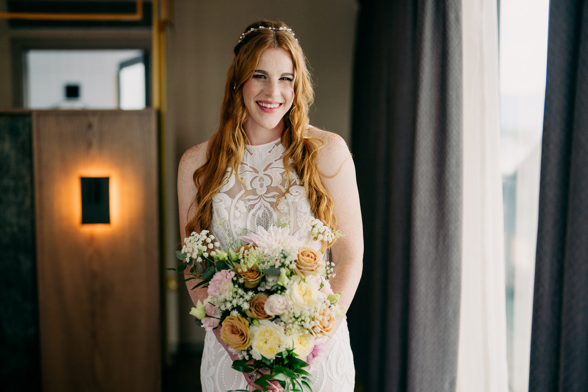 A person in a dress holding a bouquet of flowers