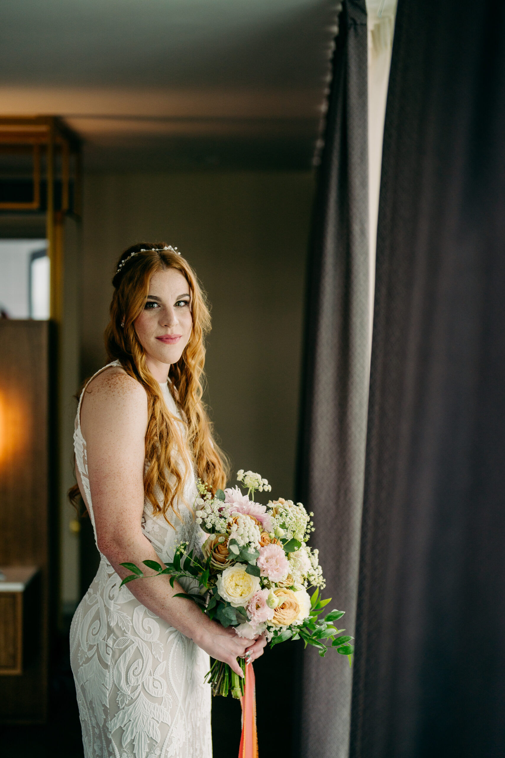 A woman in a white dress holding a bouquet of flowers