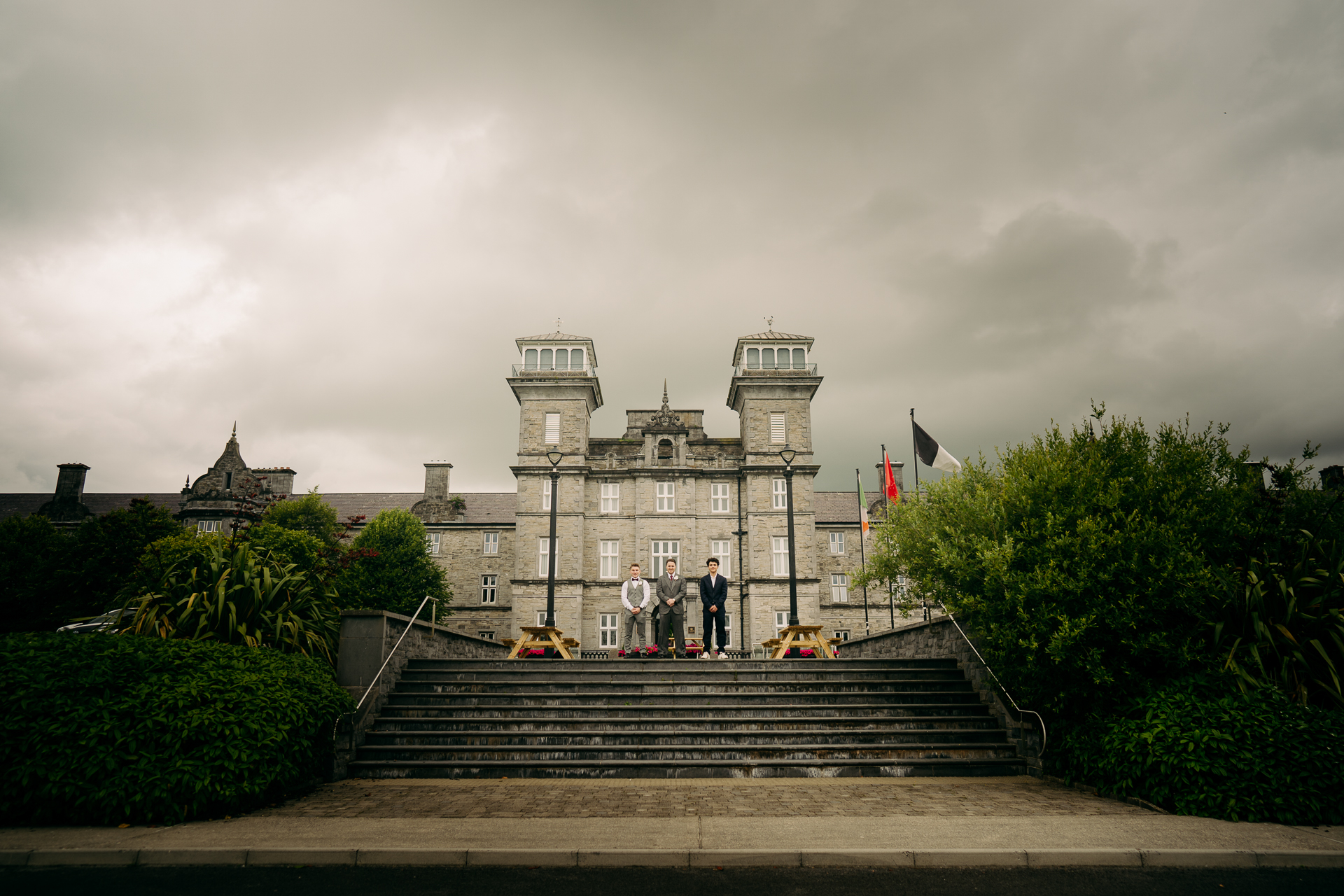 A castle with stairs and people standing on the stairs