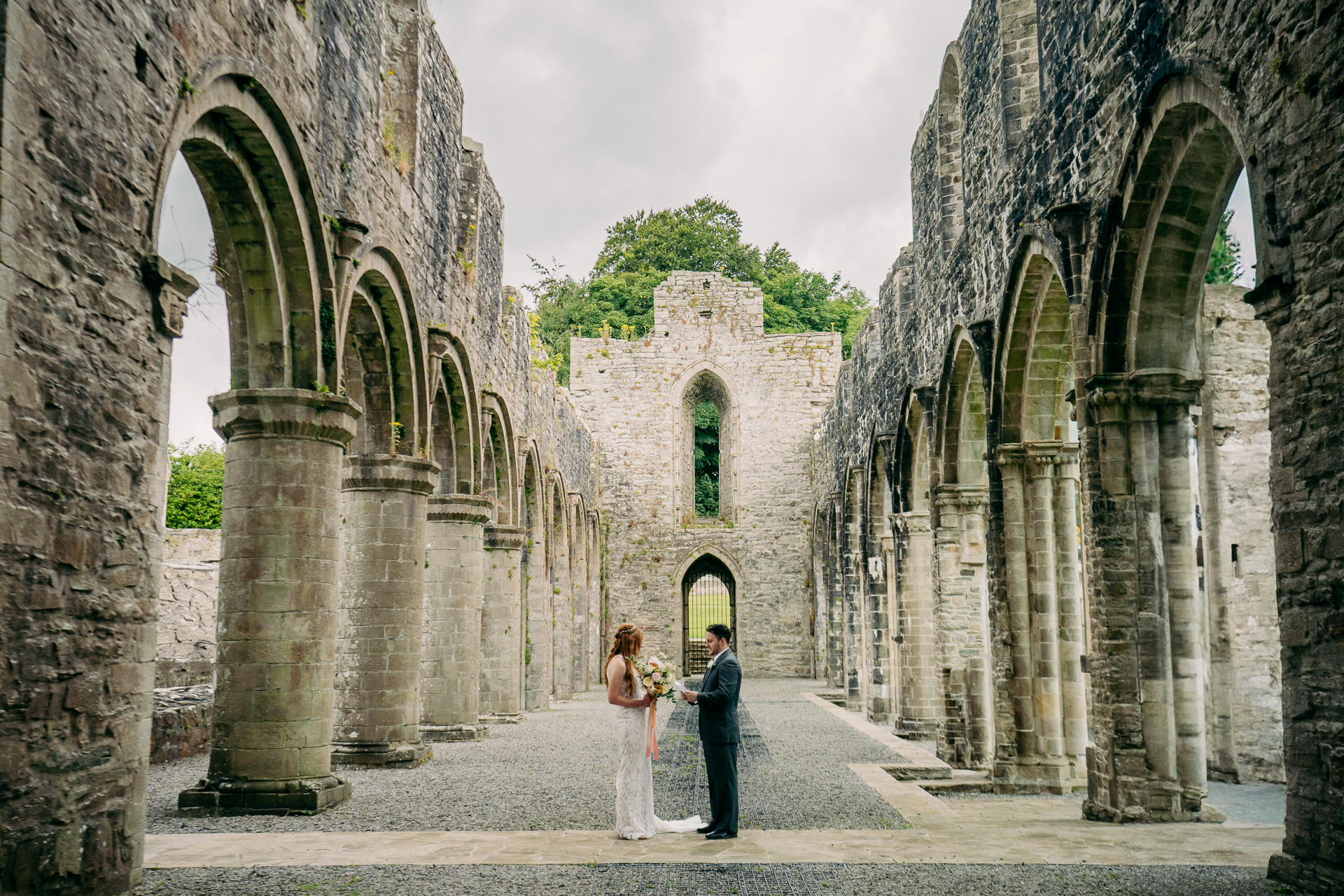 A man and woman standing in an old building