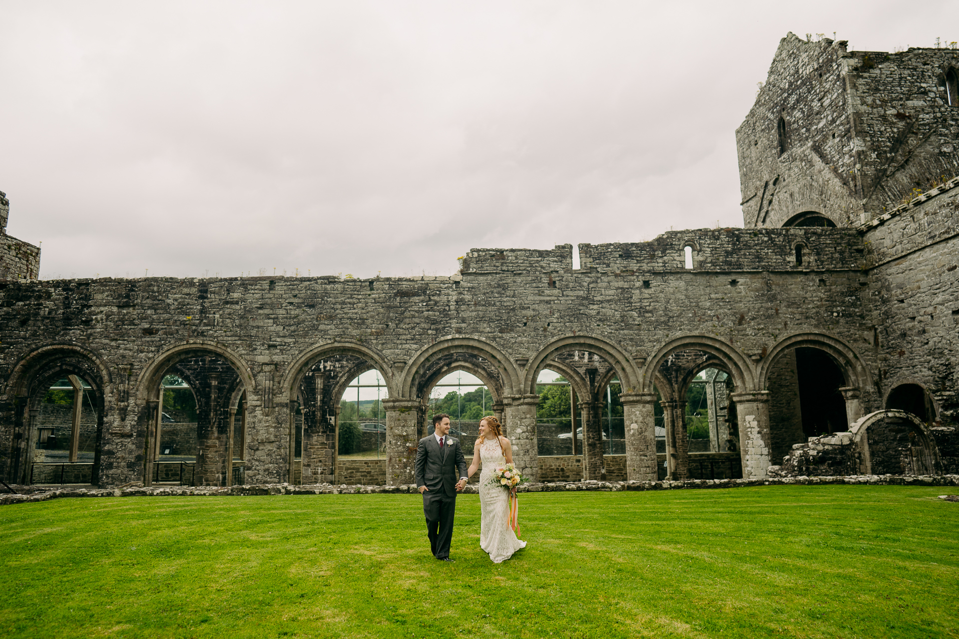 A man and woman in front of a stone building