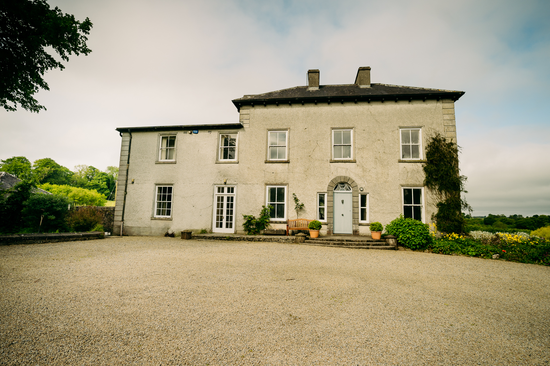 A large house with a gravel driveway