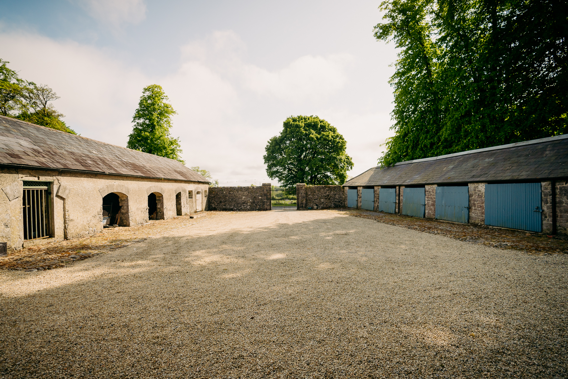 A dirt road between two buildings