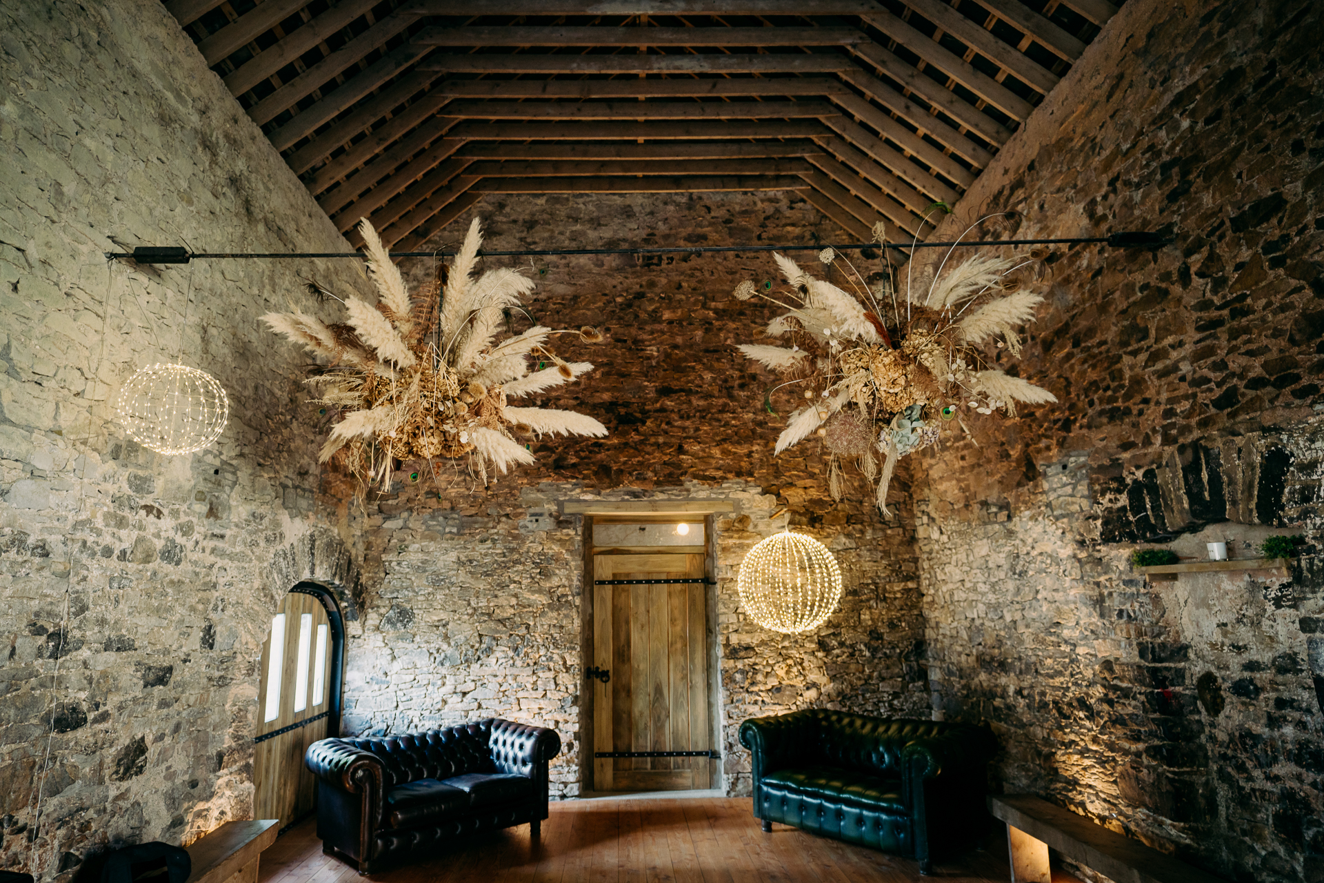 A room with a wood ceiling and a door with a light on it