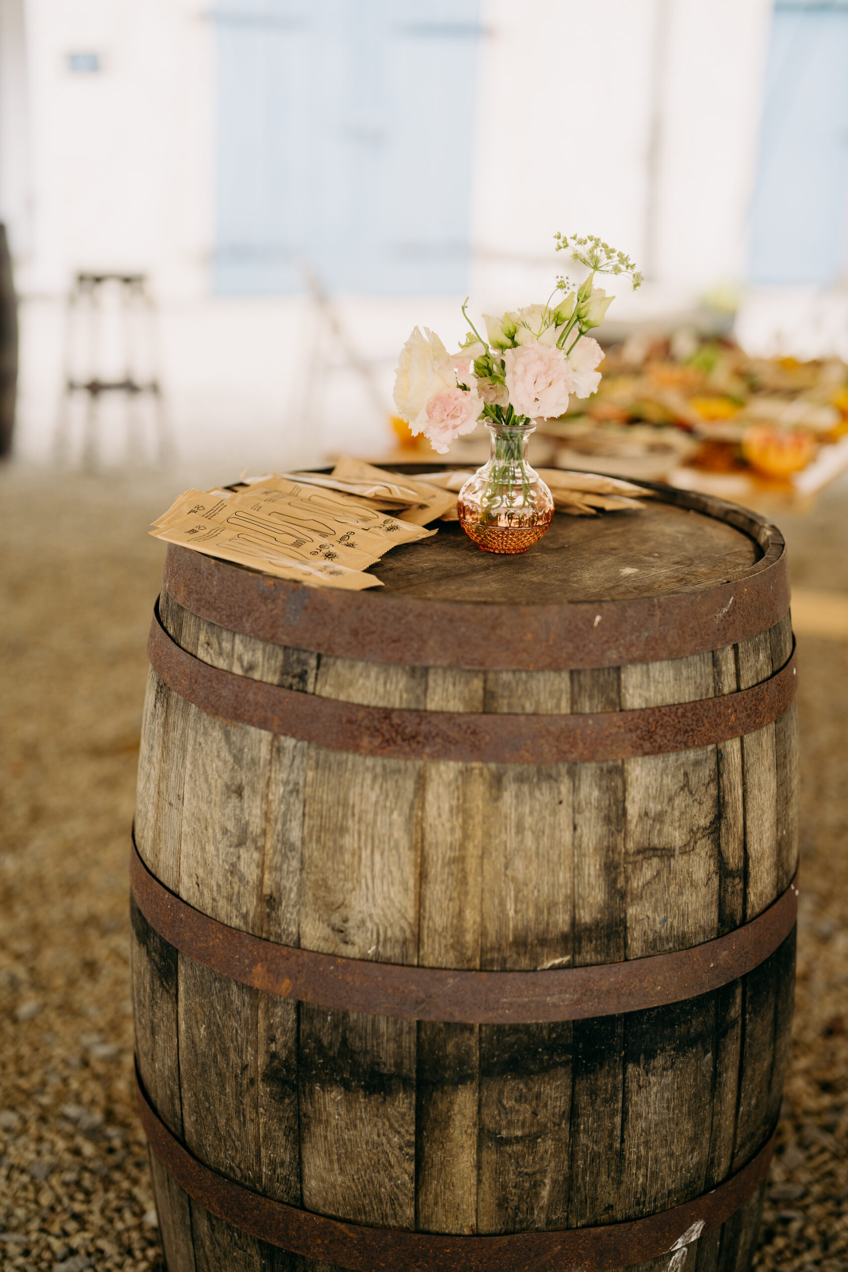 A vase with flowers on a barrel