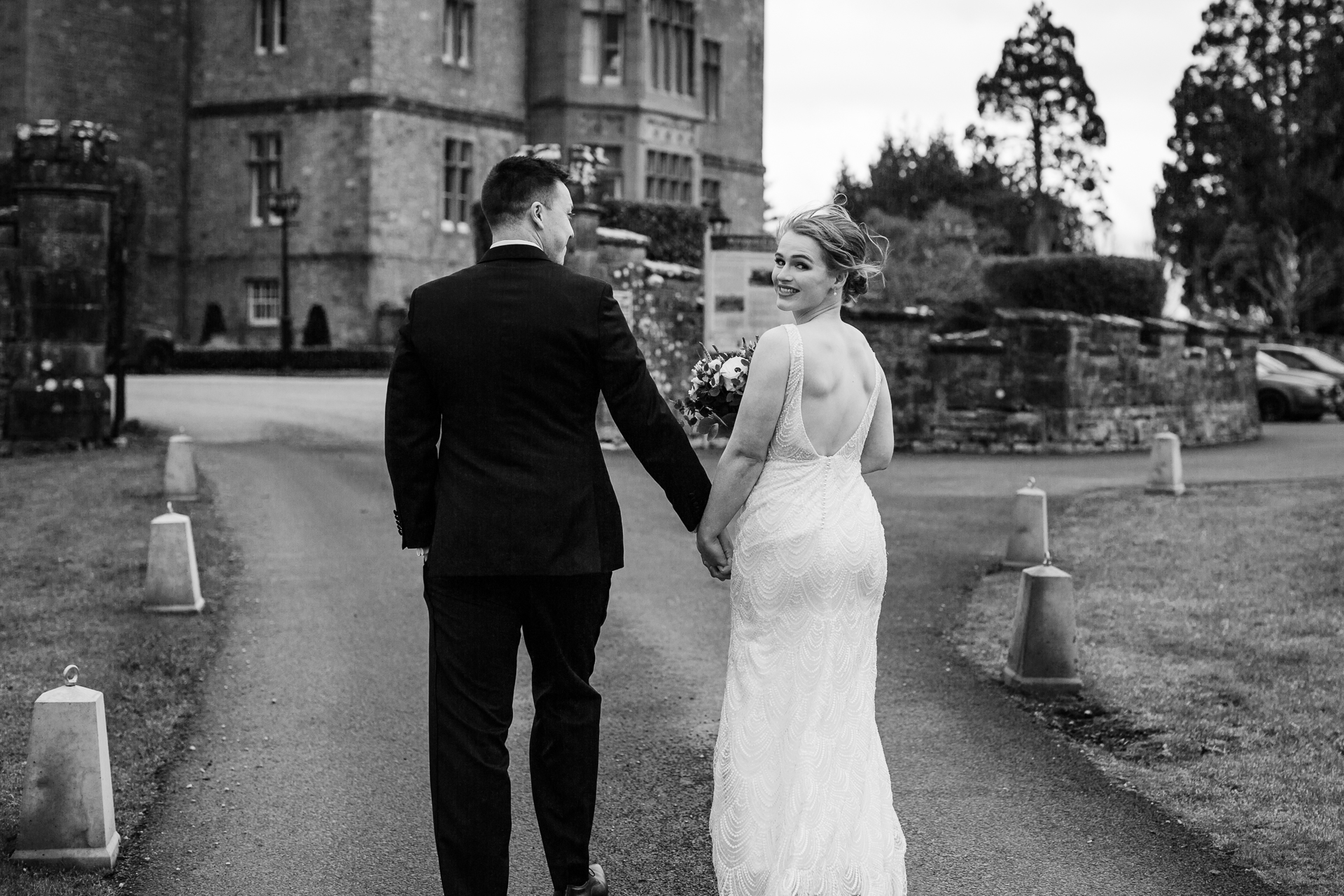 A man and woman walking down a sidewalk