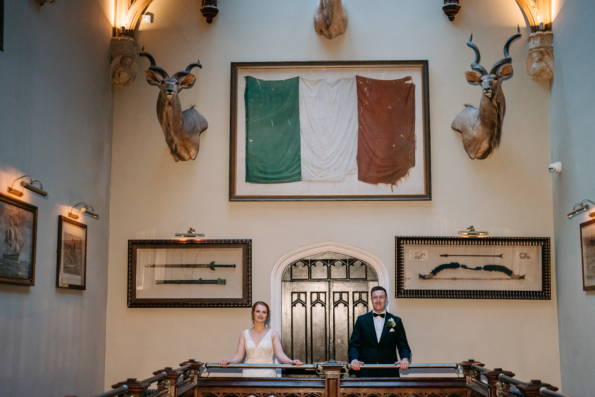 A man and woman sitting at a table in a room with art on the wall