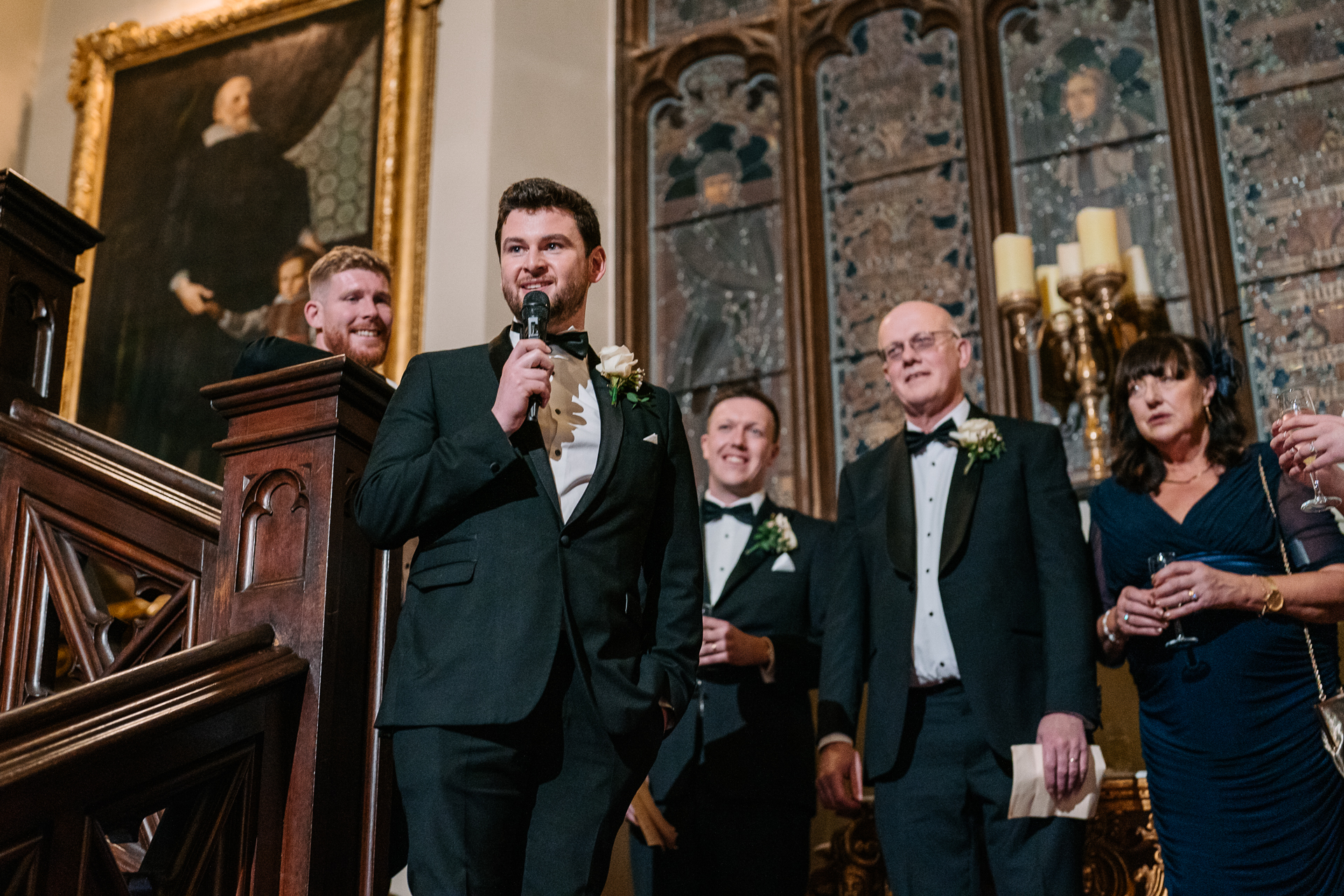 A group of people standing in a room with a person holding a microphone