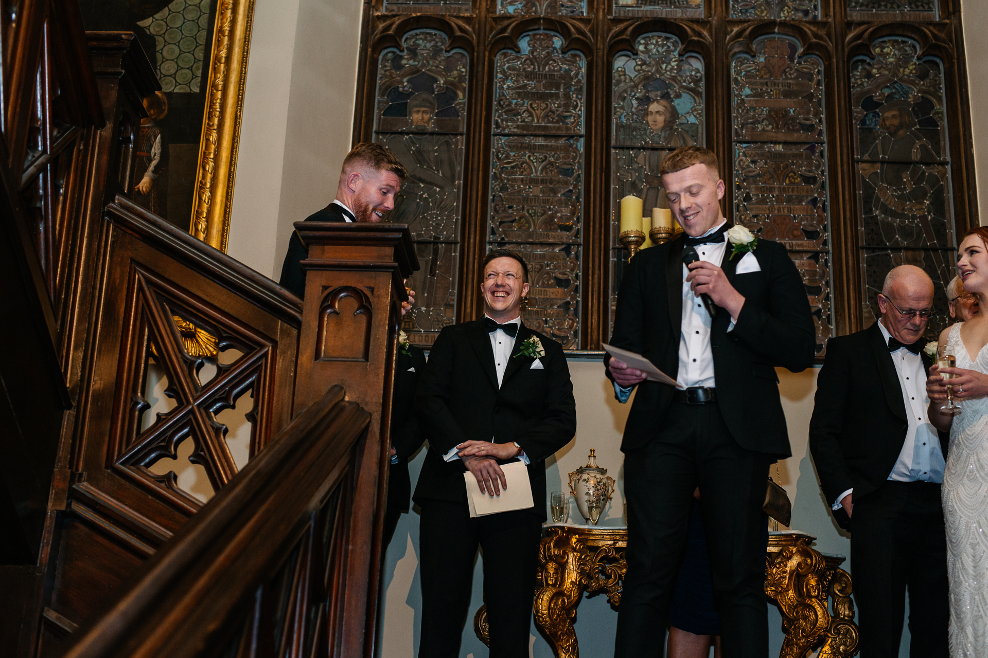 A group of people in suits standing in a church