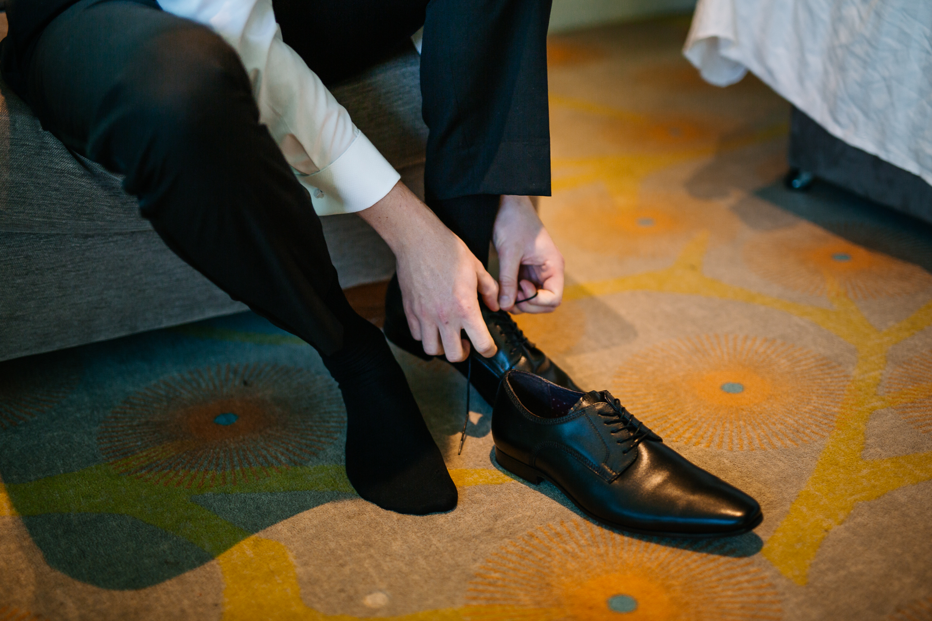 A person's feet on a yellow and black floor