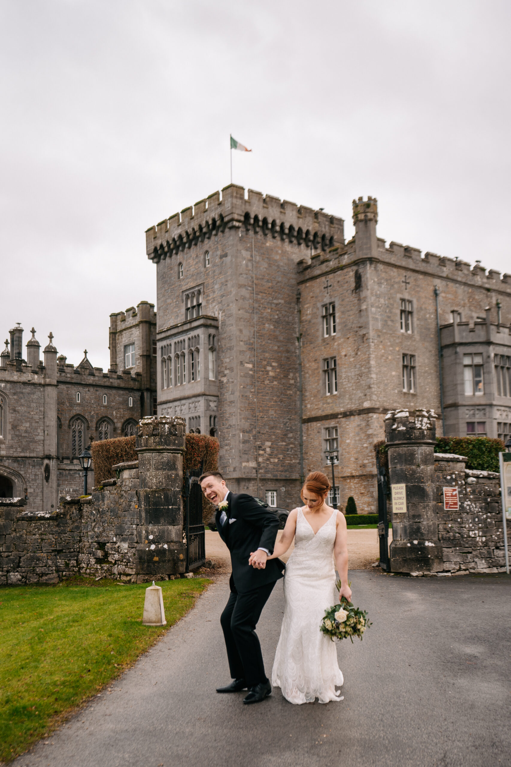 A man and woman in front of a castle