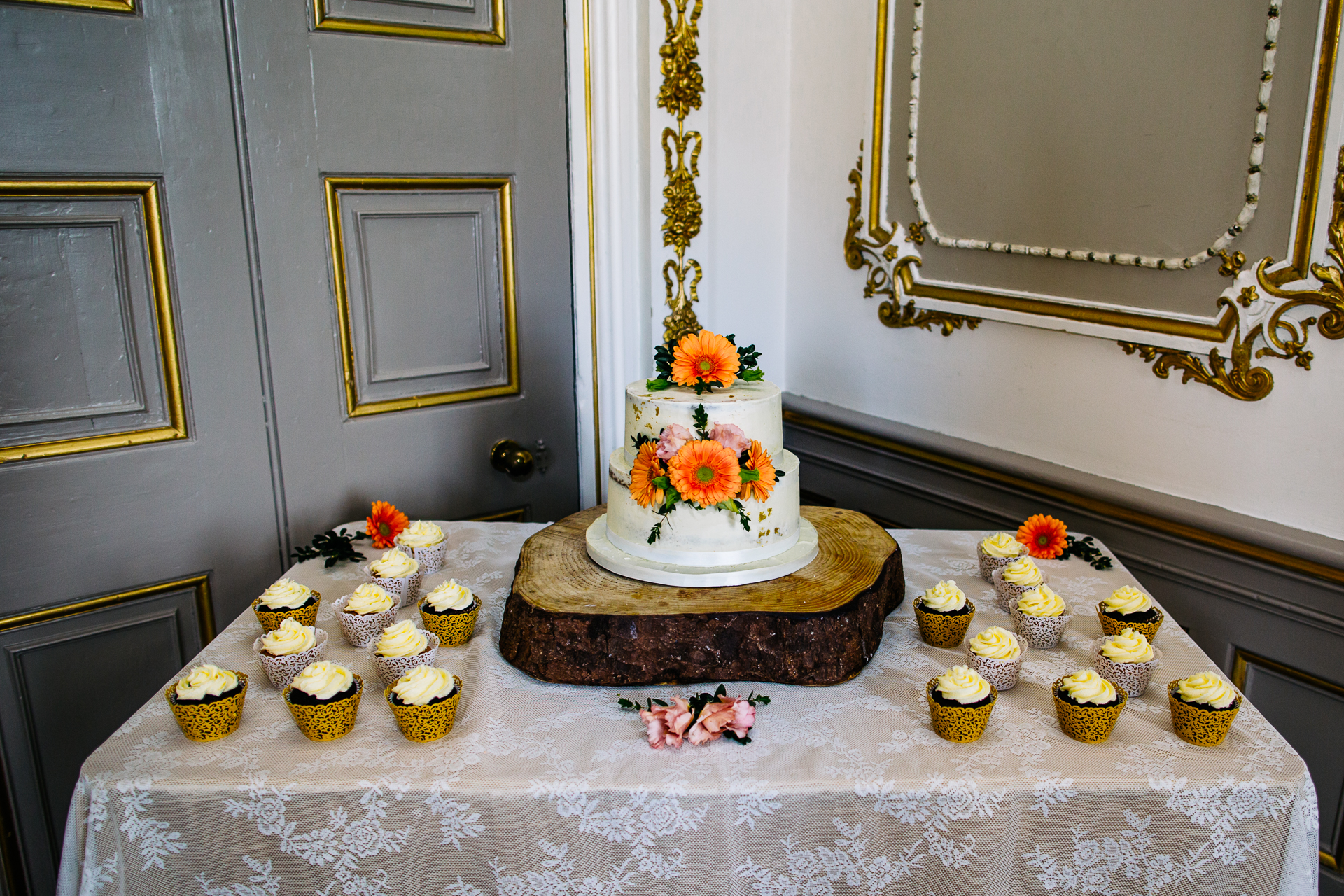 A beautifully decorated wedding cake and the cake-cutting ceremony of two grooms during their LGBT wedding at Markree Castle, Ireland.