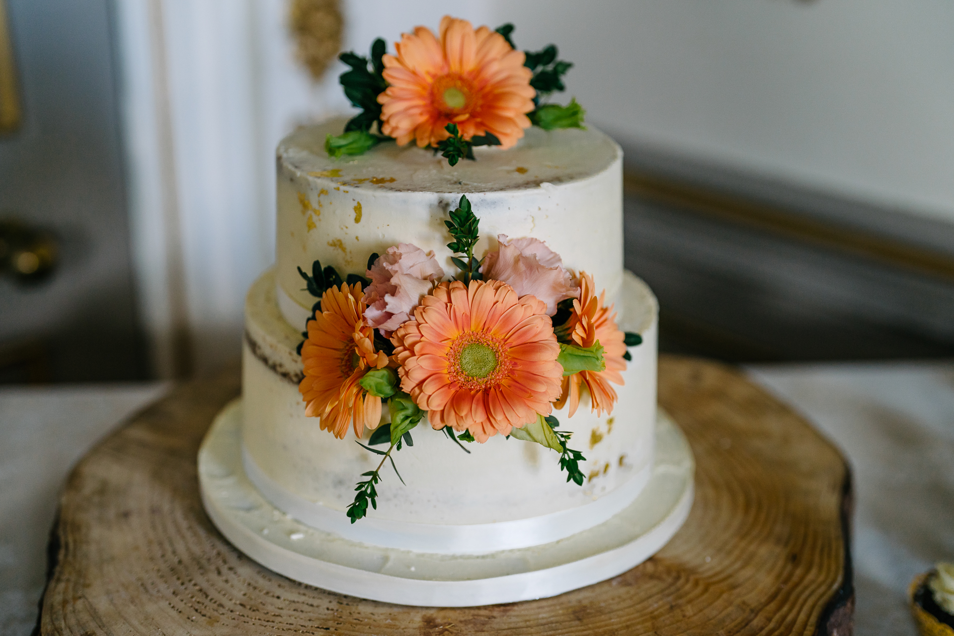 A beautifully decorated wedding cake and the cake-cutting ceremony of two grooms during their LGBT wedding at Markree Castle, Ireland.