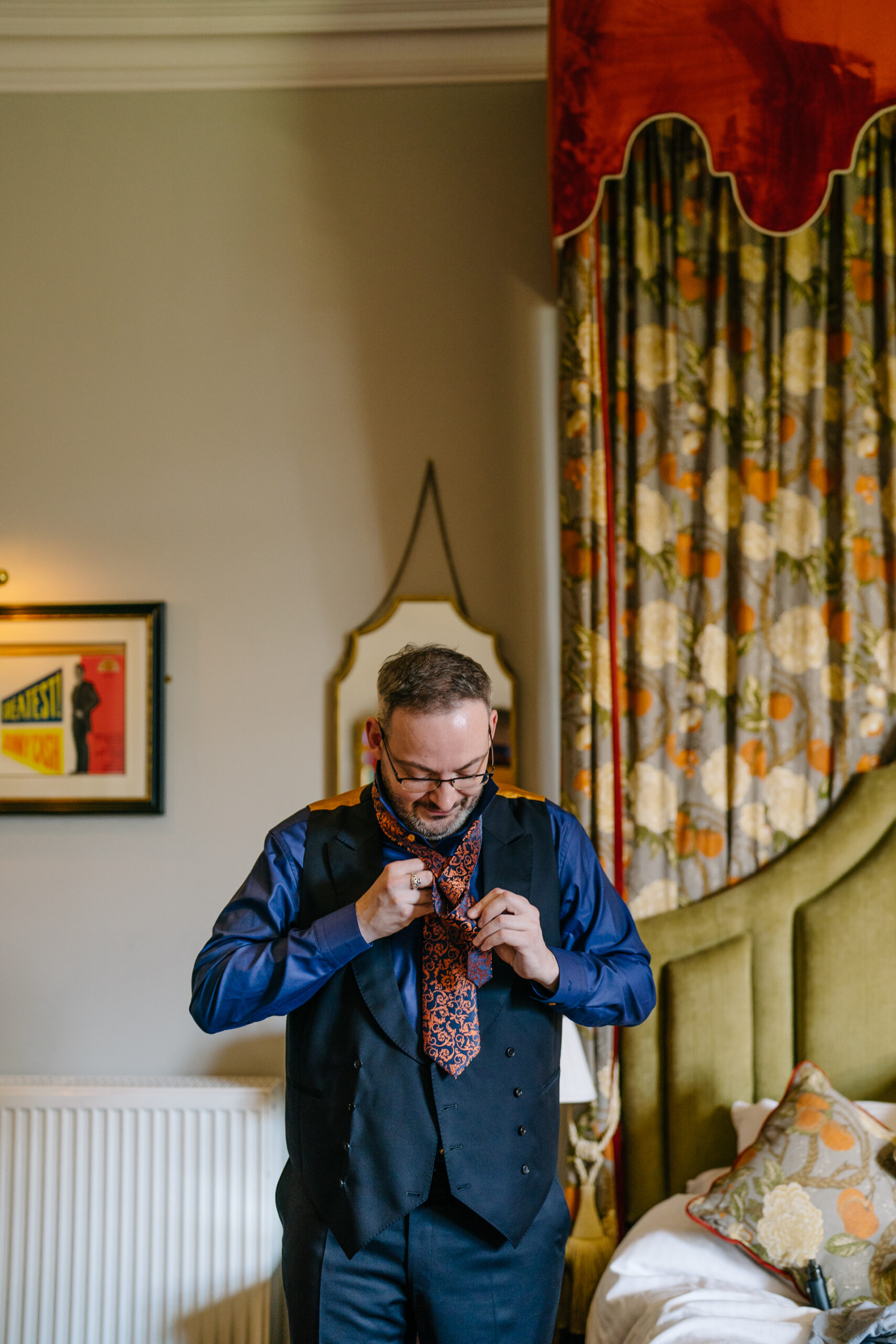 Two grooms preparing for their LGBT wedding in the bridal suite at Markree Castle, featuring elegant wedding details." "A groom adjusting his tie in the luxurious suite of Markree Castle." "Wedding details, including cufflinks and shoes, during the preparation of two grooms at Markree Castle"A groom adjusting his tie in the luxurious suite of Markree Castle." "Wedding details, including cufflinks and shoes, during the preparation of two grooms at Markree Castle