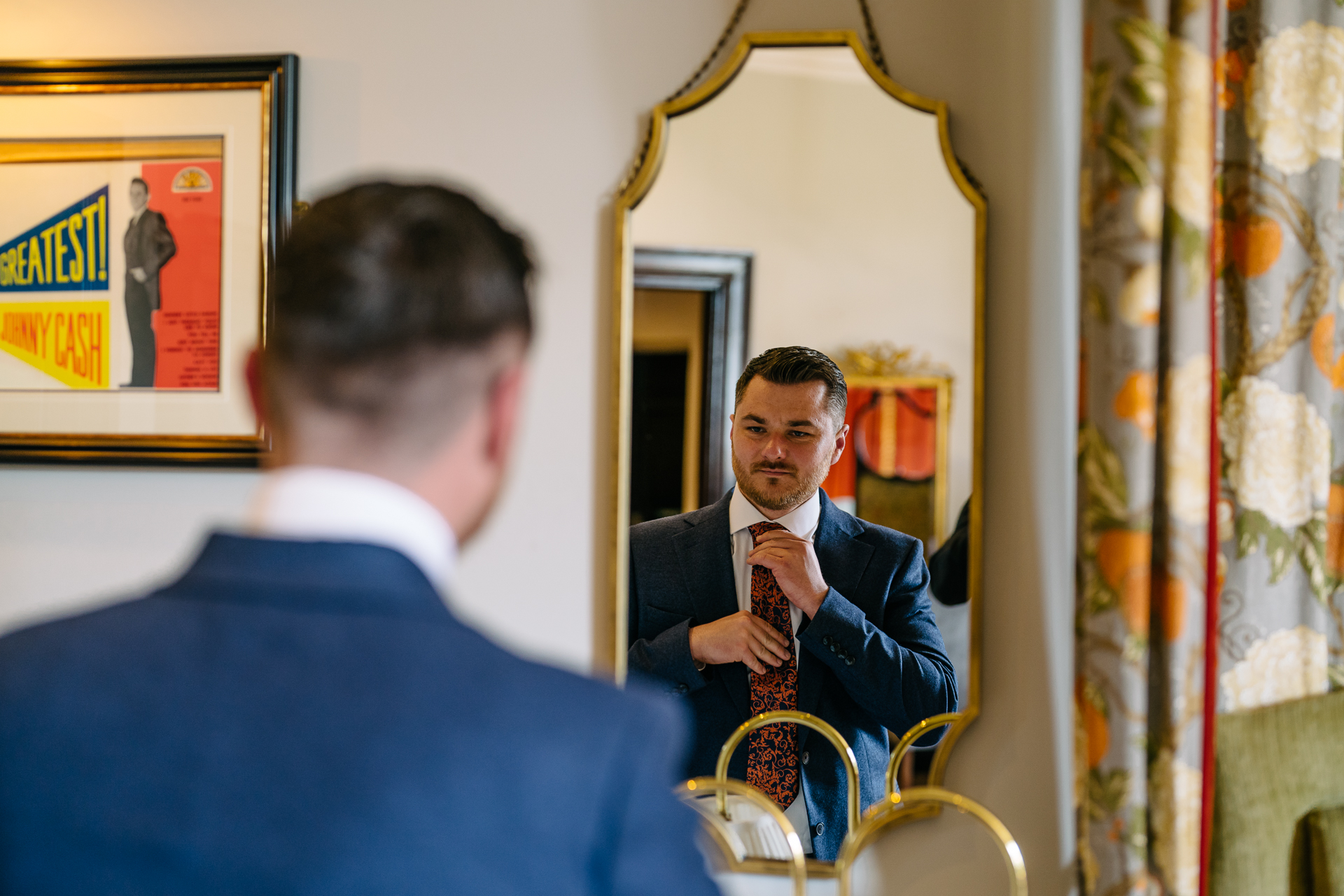 Two grooms preparing for their LGBT wedding in the bridal suite at Markree Castle, featuring elegant wedding details." "A groom adjusting his tie in the luxurious suite of Markree Castle." "Wedding details, including cufflinks and shoes, during the preparation of two grooms at Markree Castle"A groom adjusting his tie in the luxurious suite of Markree Castle." "Wedding details, including cufflinks and shoes, during the preparation of two grooms at Markree Castle