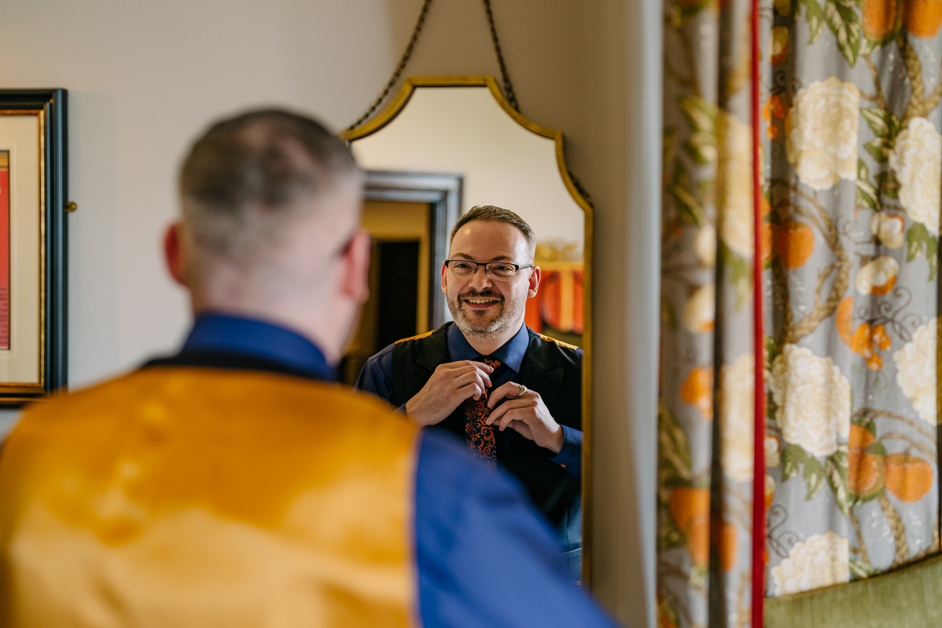 Two grooms preparing for their LGBT wedding in the bridal suite at Markree Castle, featuring elegant wedding details." "A groom adjusting his tie in the luxurious suite of Markree Castle." "Wedding details, including cufflinks and shoes, during the preparation of two grooms at Markree Castle"A groom adjusting his tie in the luxurious suite of Markree Castle." "Wedding details, including cufflinks and shoes, during the preparation of two grooms at Markree Castle