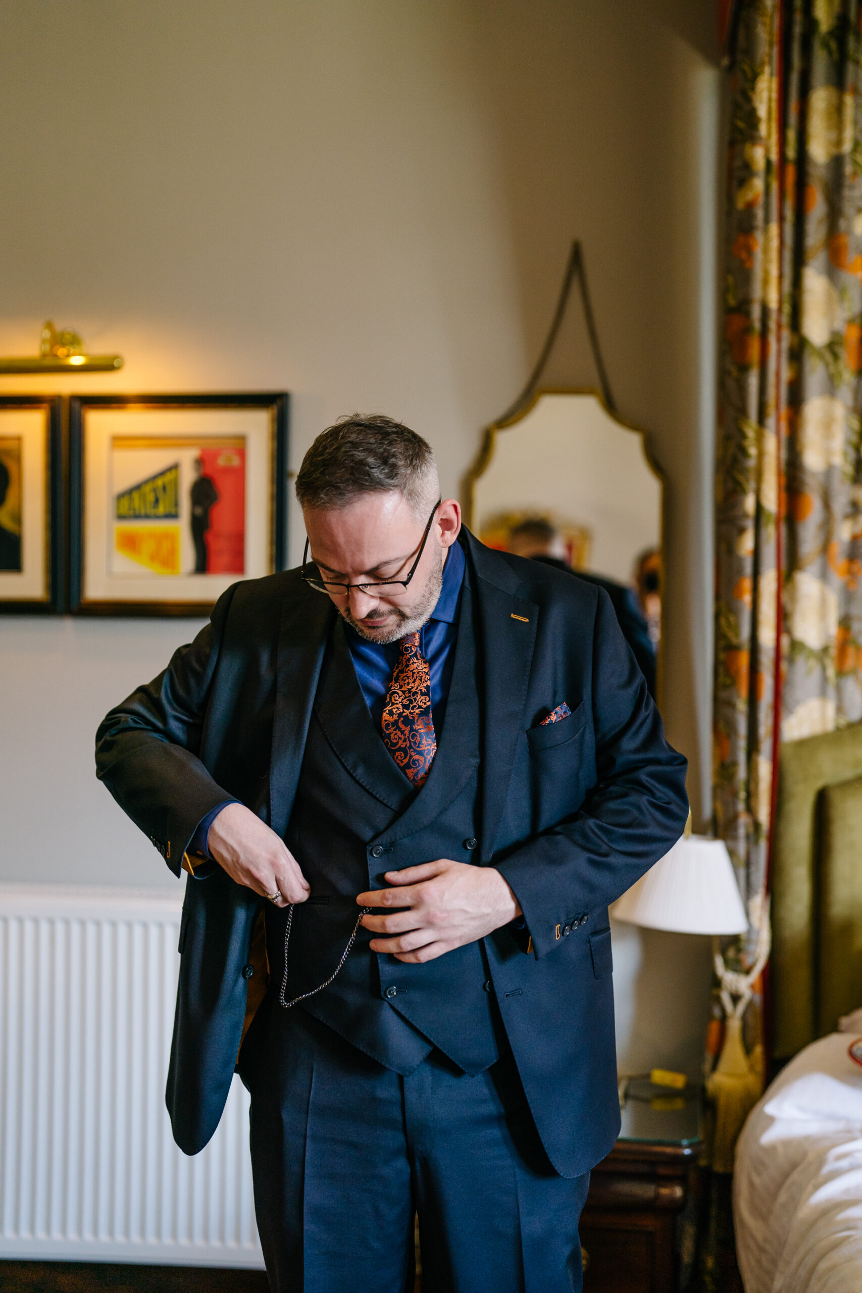 Two grooms preparing for their LGBT wedding in the bridal suite at Markree Castle, featuring elegant wedding details." "A groom adjusting his tie in the luxurious suite of Markree Castle." "Wedding details, including cufflinks and shoes, during the preparation of two grooms at Markree Castle"A groom adjusting his tie in the luxurious suite of Markree Castle." "Wedding details, including cufflinks and shoes, during the preparation of two grooms at Markree Castle