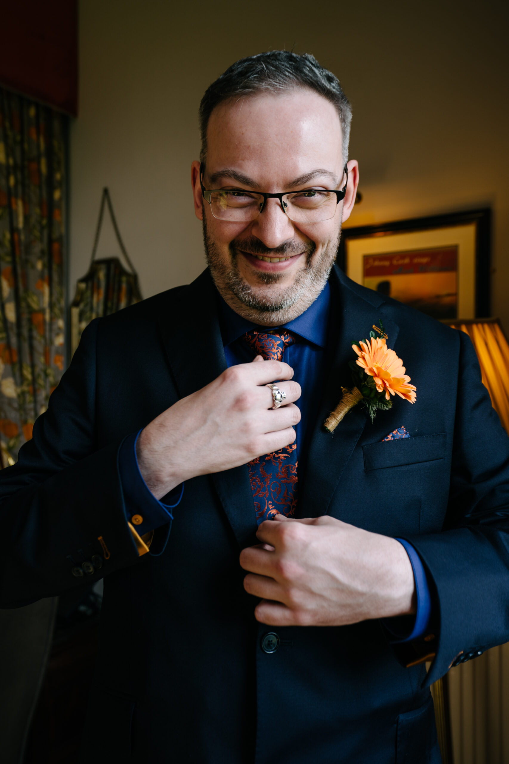 Two grooms preparing for their LGBT wedding in the bridal suite at Markree Castle, featuring elegant wedding details." "A groom adjusting his tie in the luxurious suite of Markree Castle." "Wedding details, including cufflinks and shoes, during the preparation of two grooms at Markree Castle"A groom adjusting his tie in the luxurious suite of Markree Castle." "Wedding details, including cufflinks and shoes, during the preparation of two grooms at Markree Castle