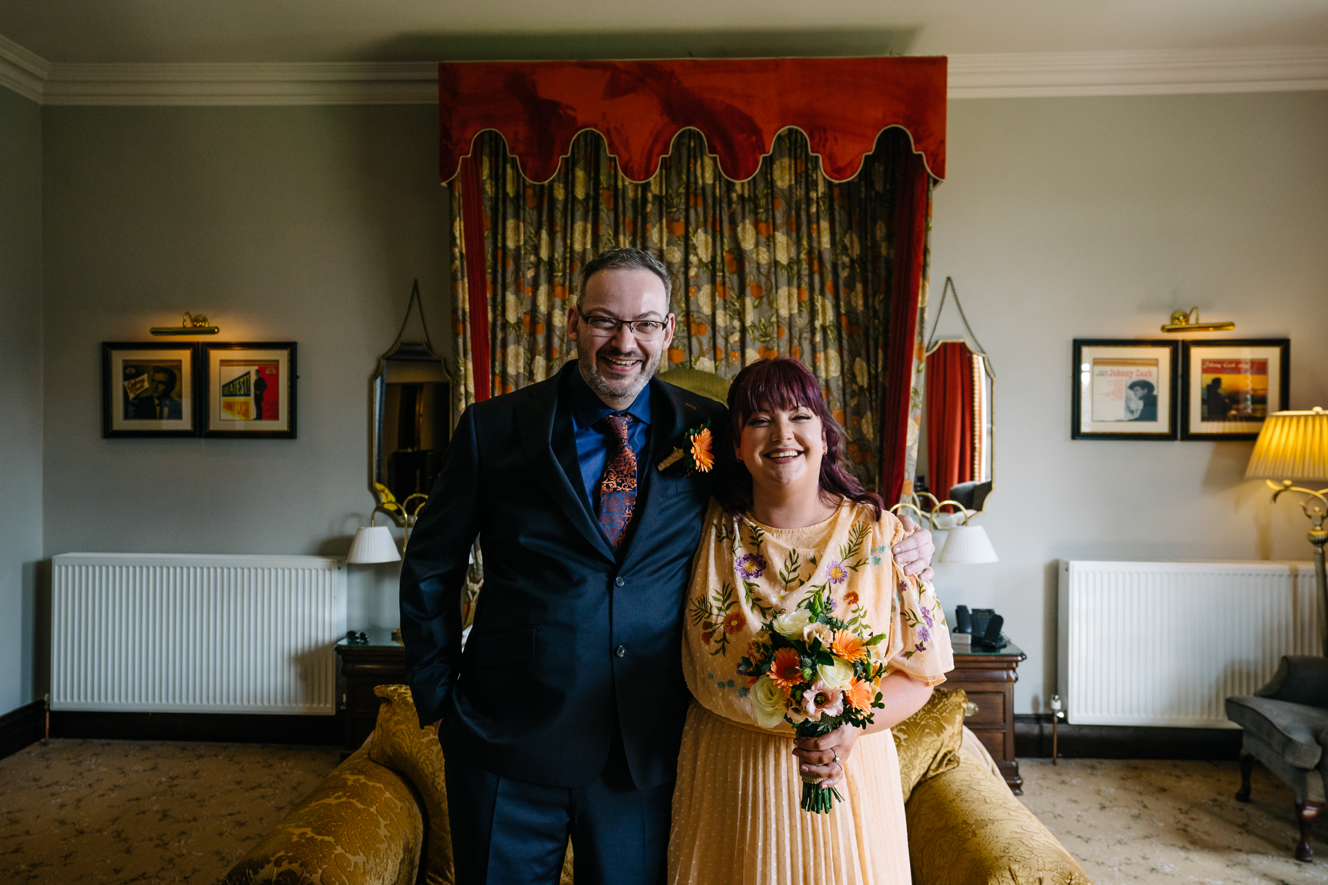 Two grooms preparing for their LGBT wedding in the bridal suite at Markree Castle, featuring elegant wedding details." "A groom adjusting his tie in the luxurious suite of Markree Castle." "Wedding details, including cufflinks and shoes, during the preparation of two grooms at Markree Castle