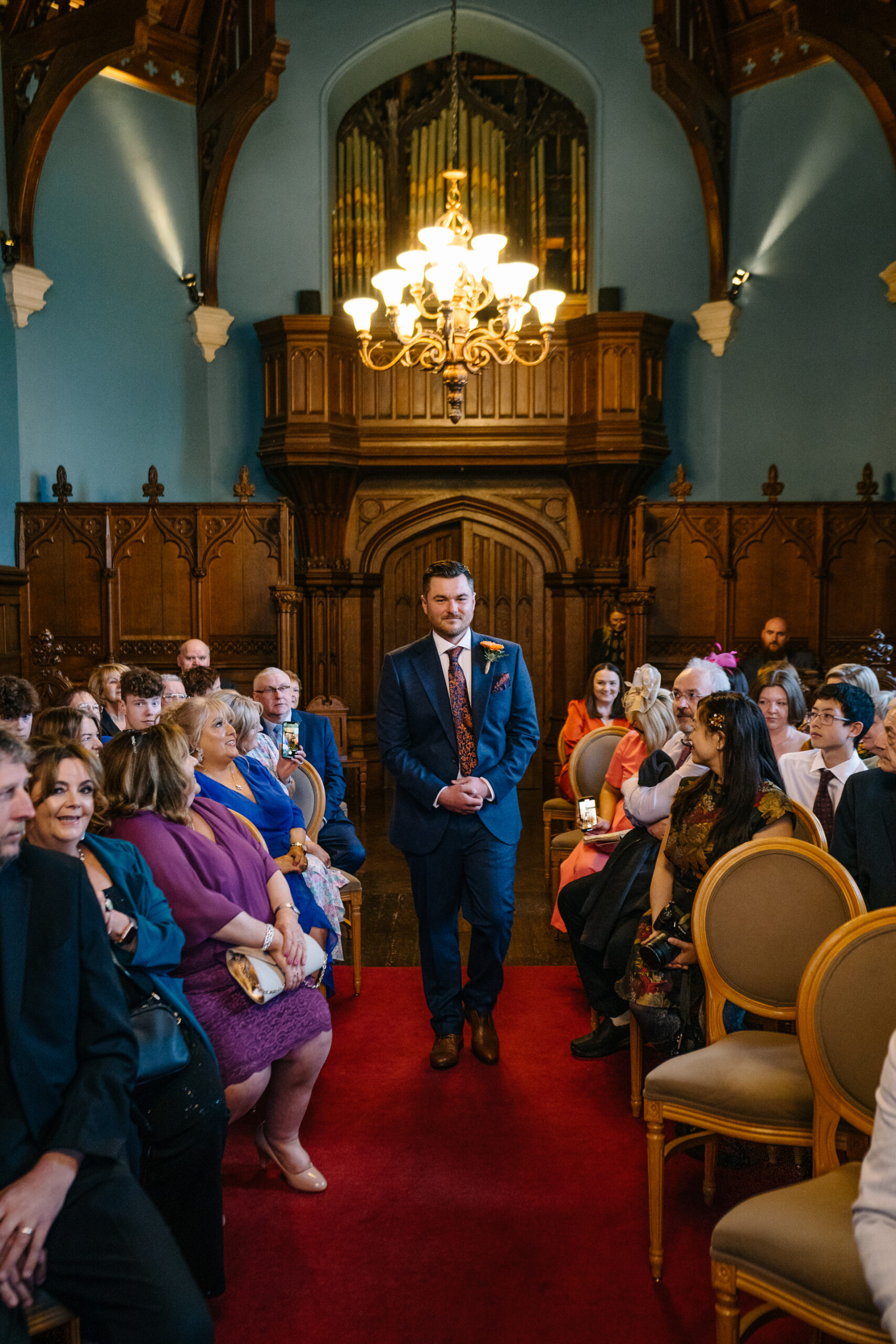 Two grooms exchanging vows during their LGBT wedding ceremony in the chapel of Markree Castle"A groom adjusting his tie in the luxurious suite of Markree Castle." "Wedding details, including cufflinks and shoes, during the preparation of two grooms at Markree Castle