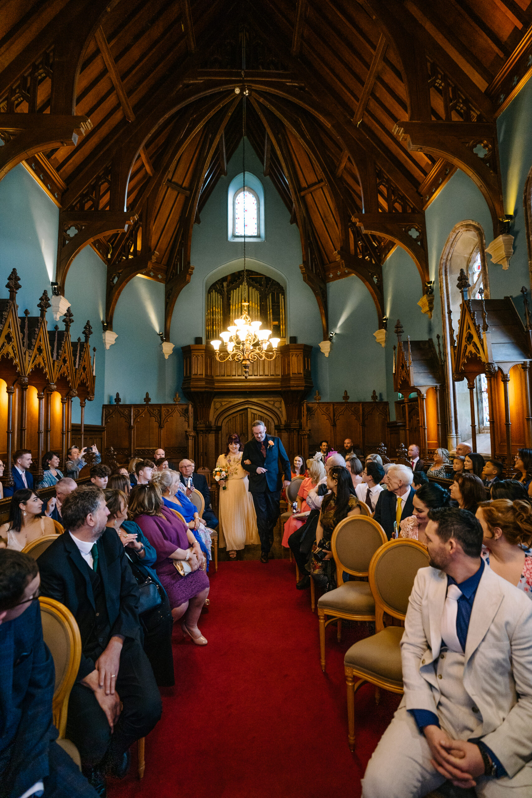 Two grooms exchanging vows during their LGBT wedding ceremony in the chapel of Markree Castle"A groom adjusting his tie in the luxurious suite of Markree Castle." "Wedding details, including cufflinks and shoes, during the preparation of two grooms at Markree Castle