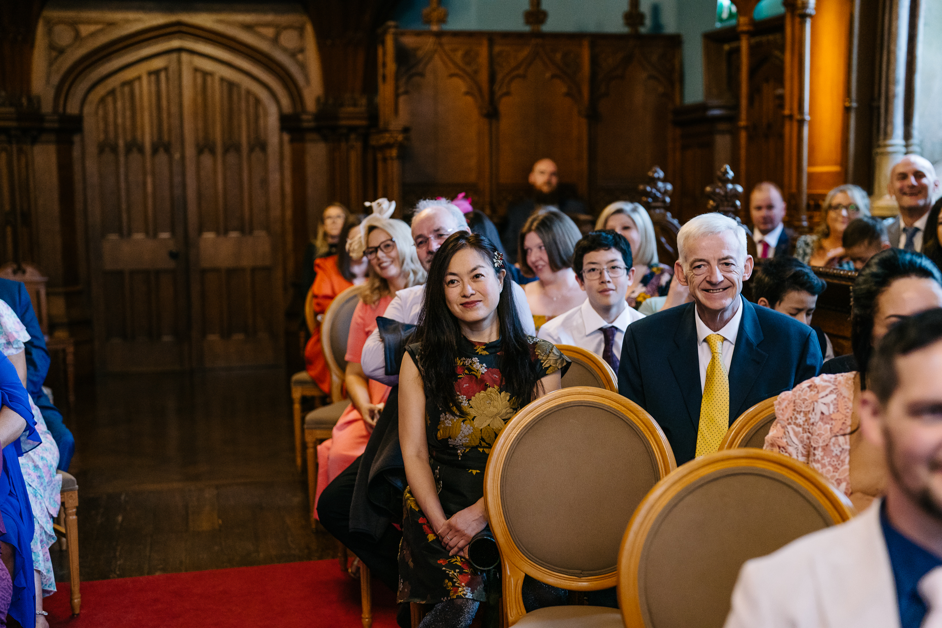 Two grooms exchanging vows during their LGBT wedding ceremony in the chapel of Markree Castle"A groom adjusting his tie in the luxurious suite of Markree Castle." "Wedding details, including cufflinks and shoes, during the preparation of two grooms at Markree Castle