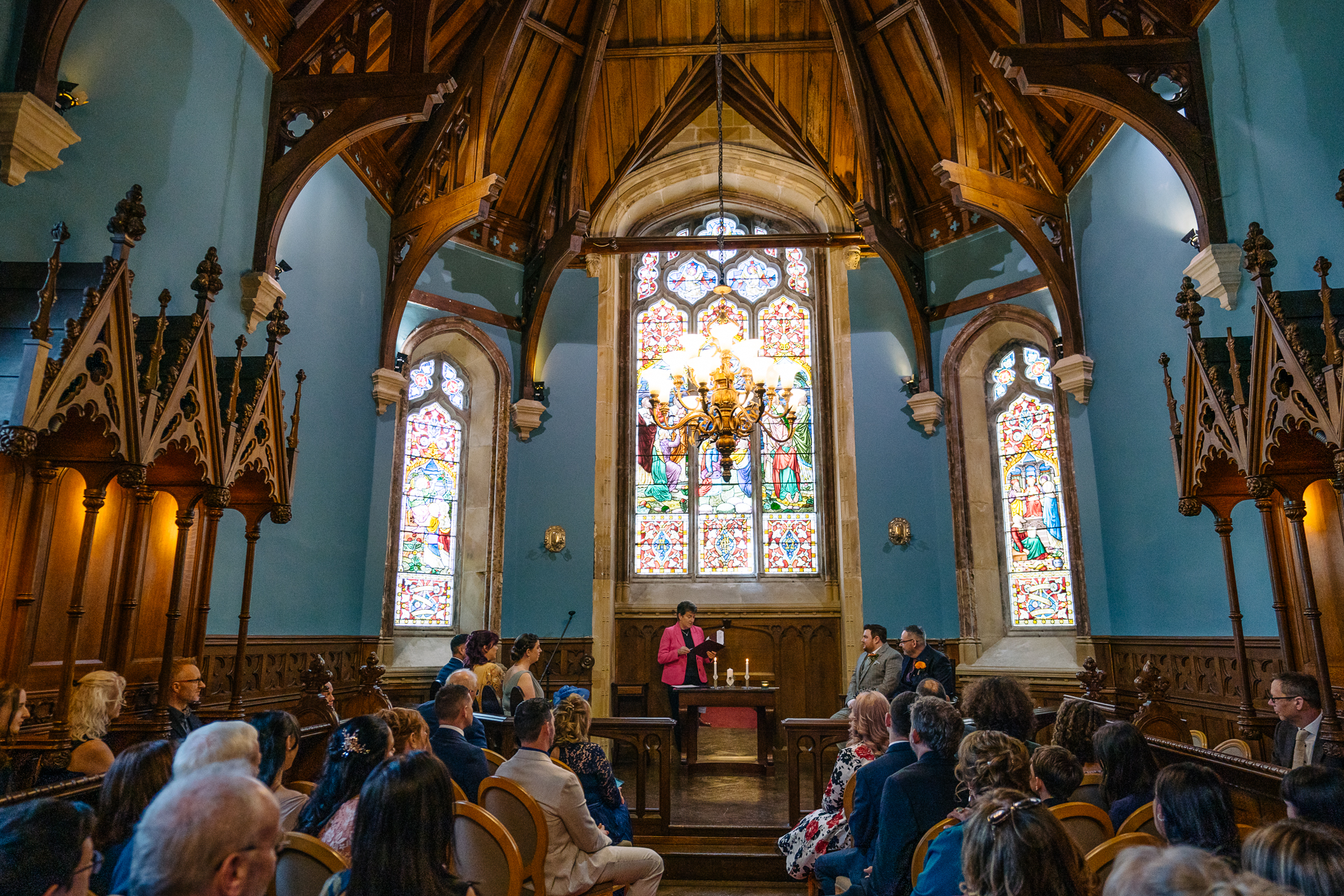 Two grooms exchanging vows during their LGBT wedding ceremony in the chapel of Markree Castle"A groom adjusting his tie in the luxurious suite of Markree Castle." "Wedding details, including cufflinks and shoes, during the preparation of two grooms at Markree Castle