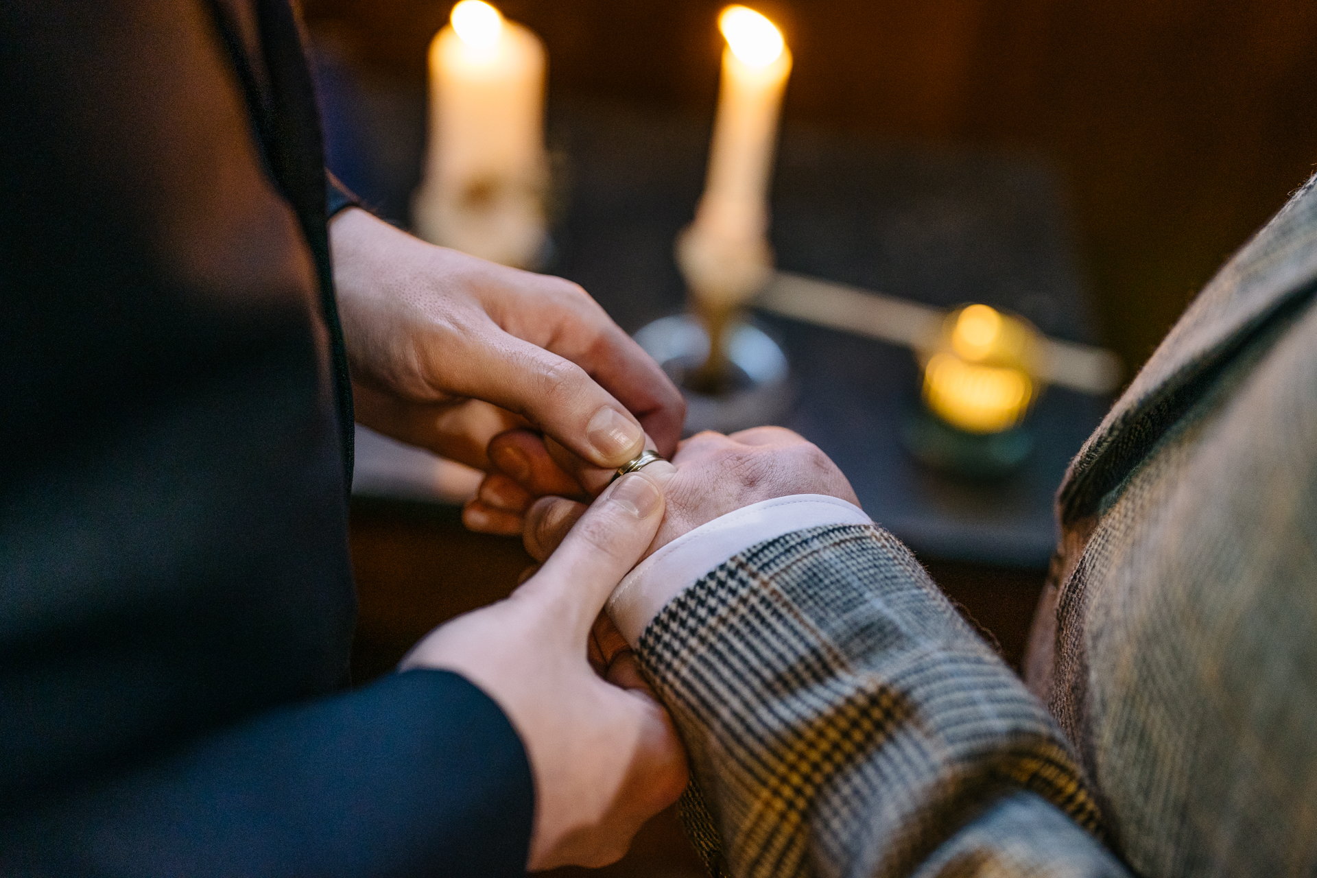 Two grooms exchanging vows during their LGBT wedding ceremony in the chapel of Markree Castle"A groom adjusting his tie in the luxurious suite of Markree Castle." "Wedding details, including cufflinks and shoes, during the preparation of two grooms at Markree Castle