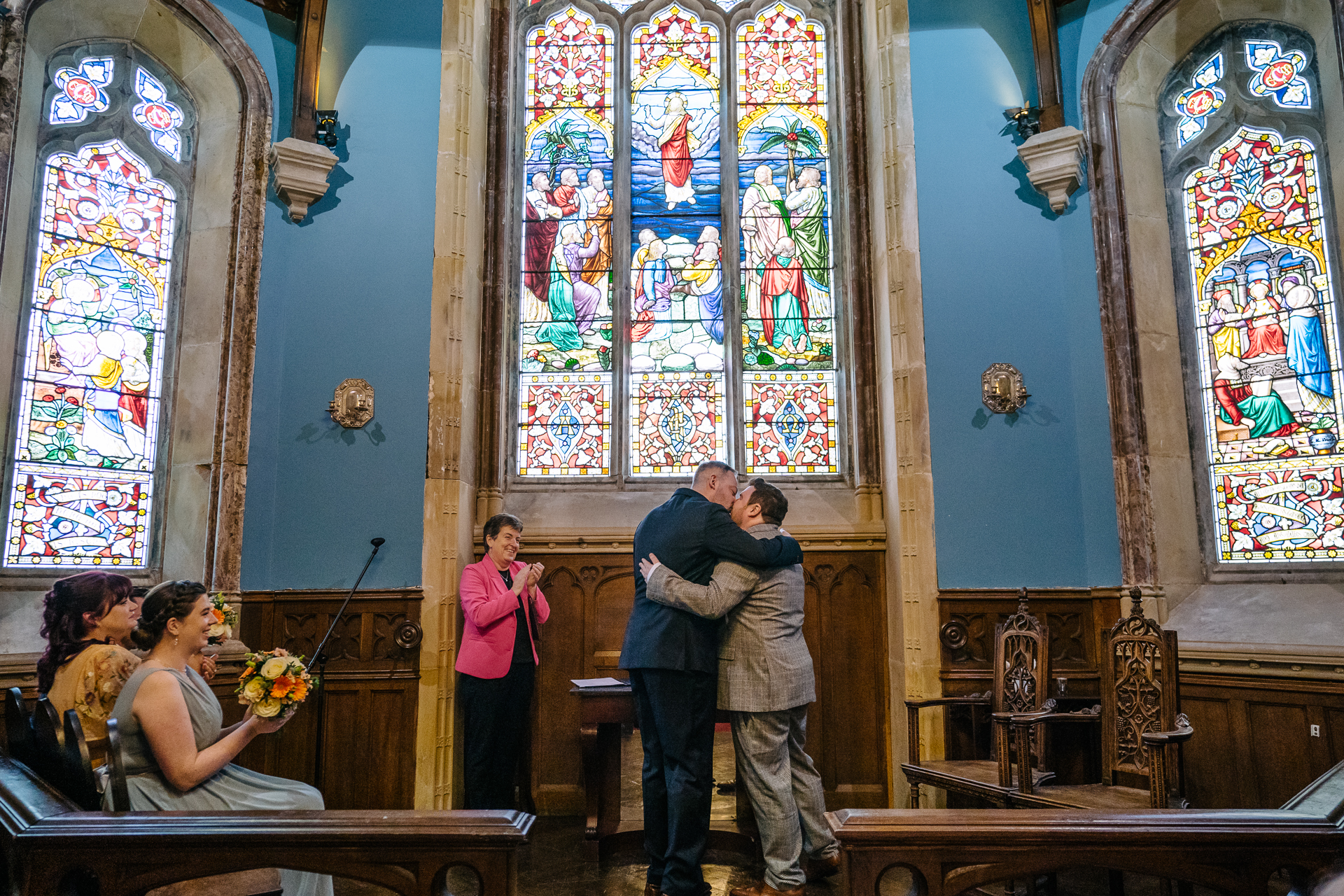 Two grooms exchanging vows during their LGBT wedding ceremony in the chapel of Markree Castle"A groom adjusting his tie in the luxurious suite of Markree Castle." "Wedding details, including cufflinks and shoes, during the preparation of two grooms at Markree Castle