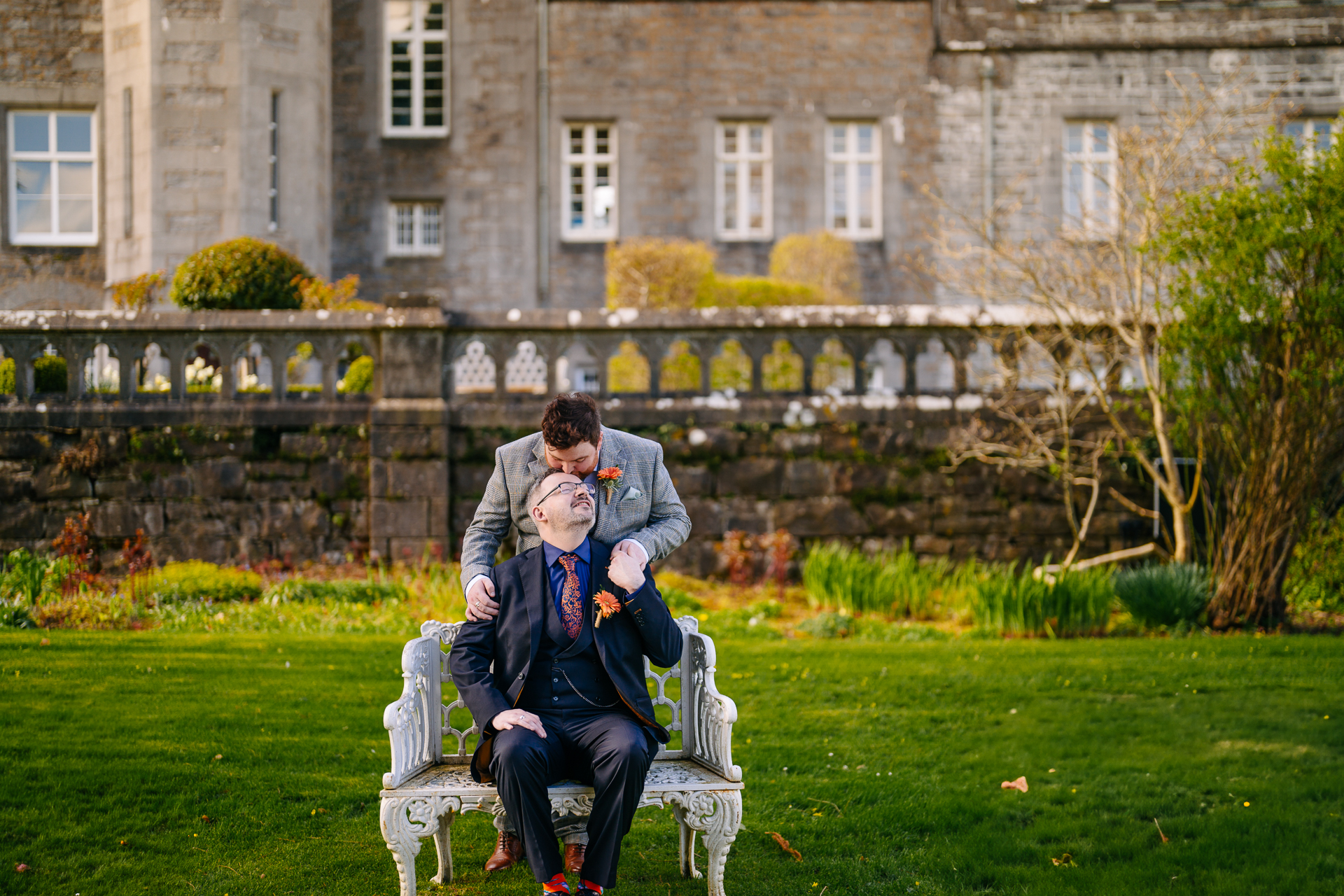 Two grooms posing for romantic wedding portraits in the gardens of Markree Castle