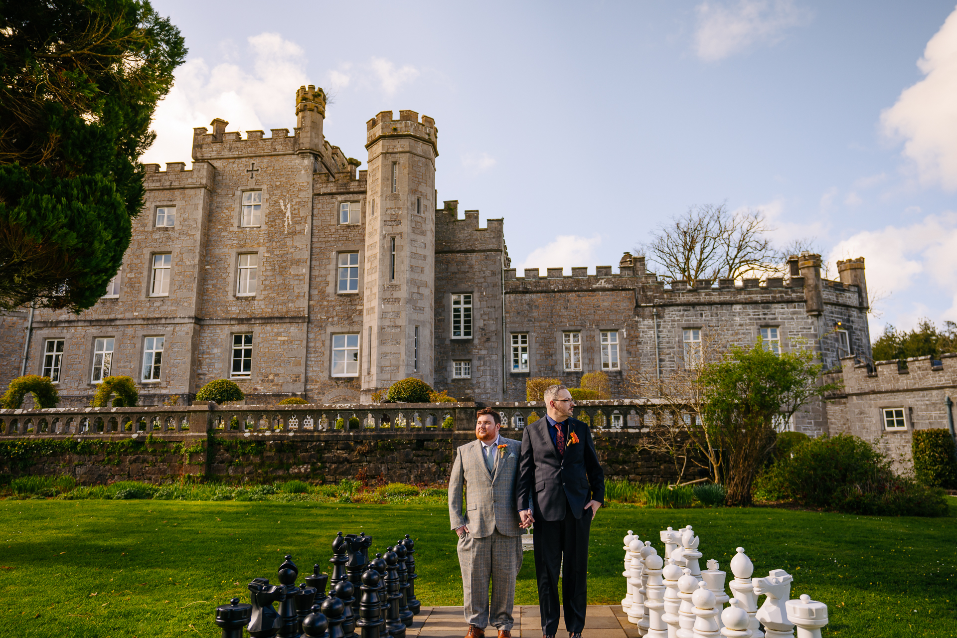 Two grooms posing for romantic wedding portraits in the gardens of Markree Castle