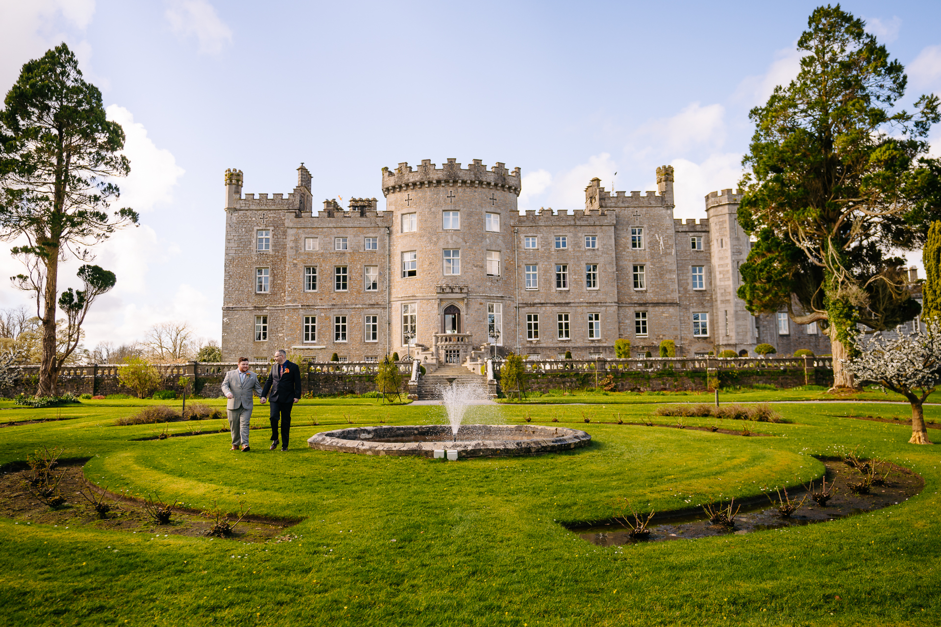 Two grooms posing for romantic wedding portraits in the gardens of Markree Castle