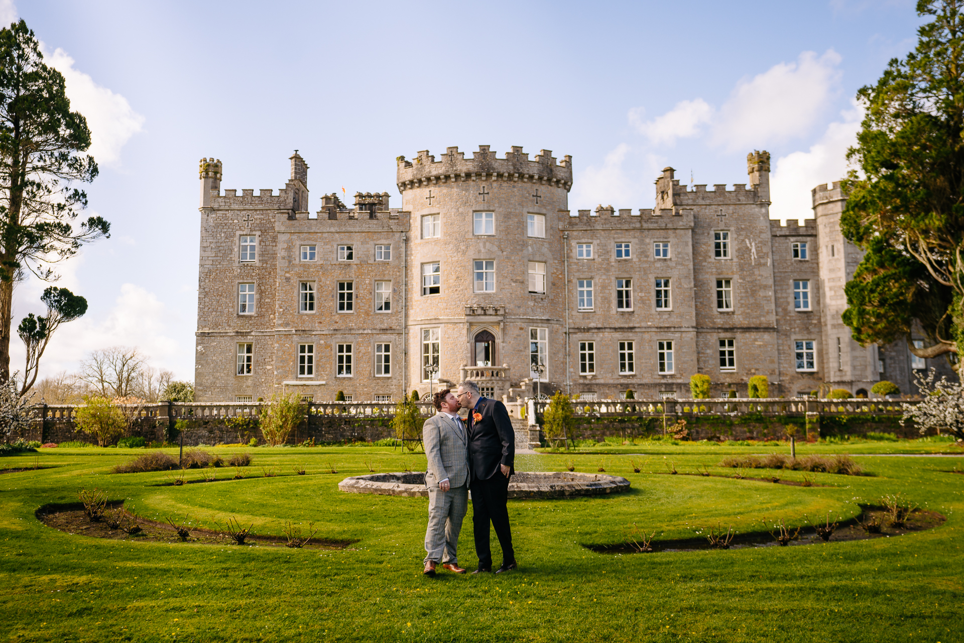 Two grooms posing for romantic wedding portraits in the gardens of Markree Castle