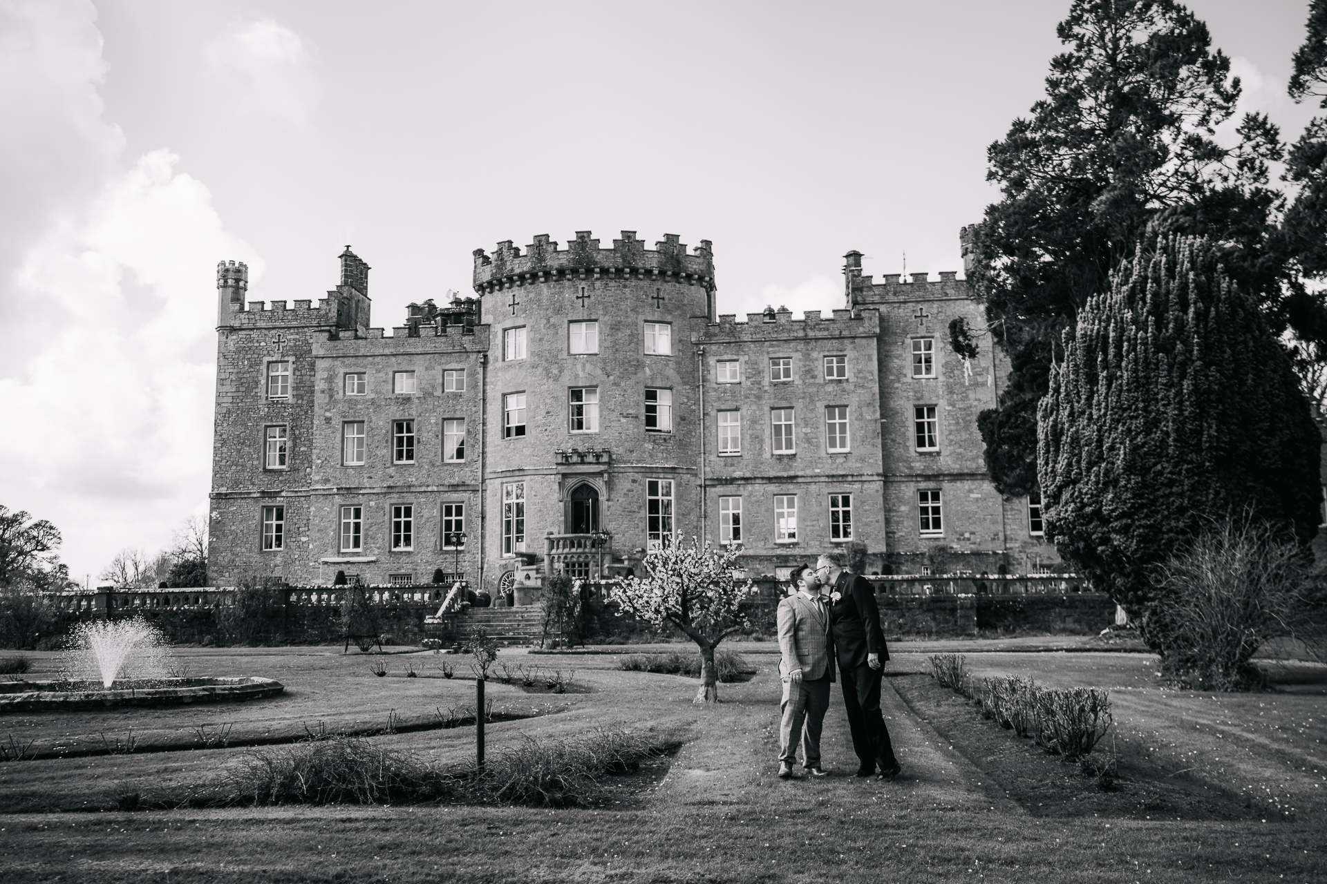 Two grooms posing for romantic wedding portraits in the gardens of Markree Castle