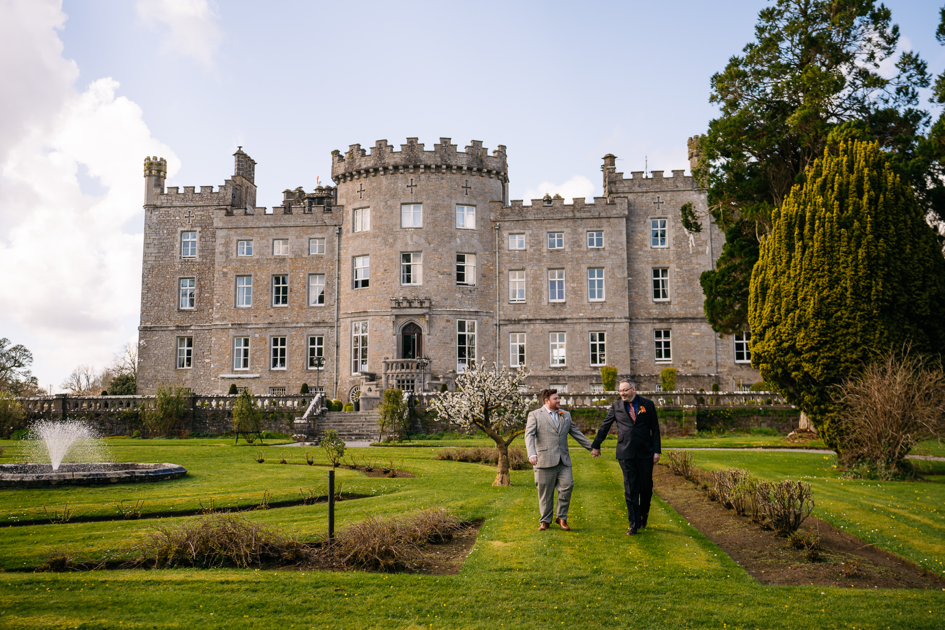 Two grooms posing for romantic wedding portraits in the gardens of Markree Castle