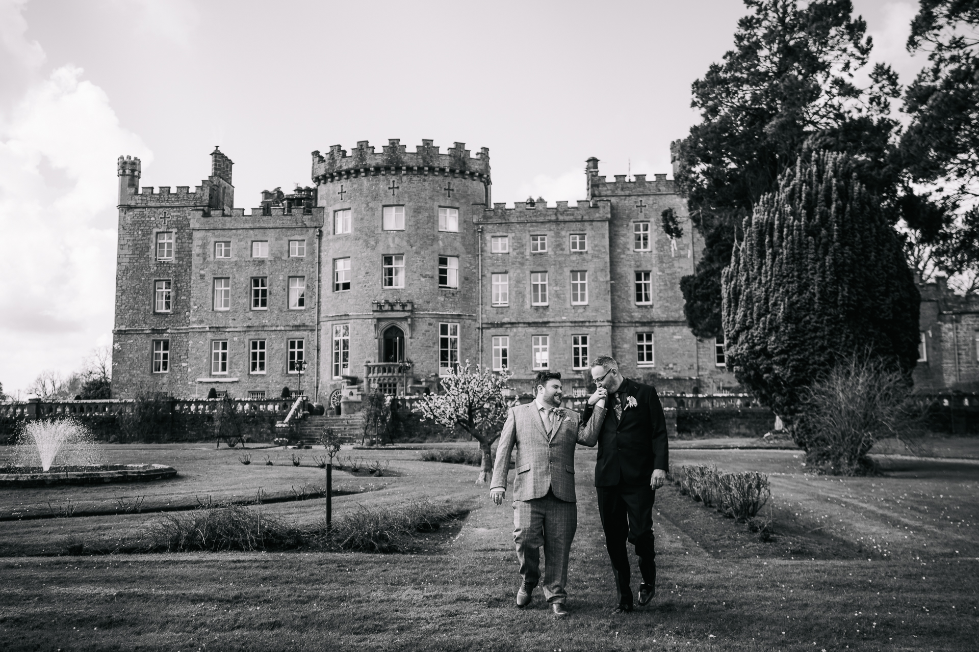 Two grooms posing for romantic wedding portraits in the gardens of Markree Castle