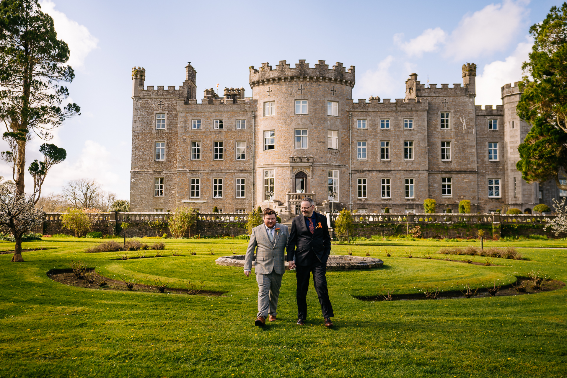 Two grooms posing for romantic wedding portraits in the gardens of Markree Castle