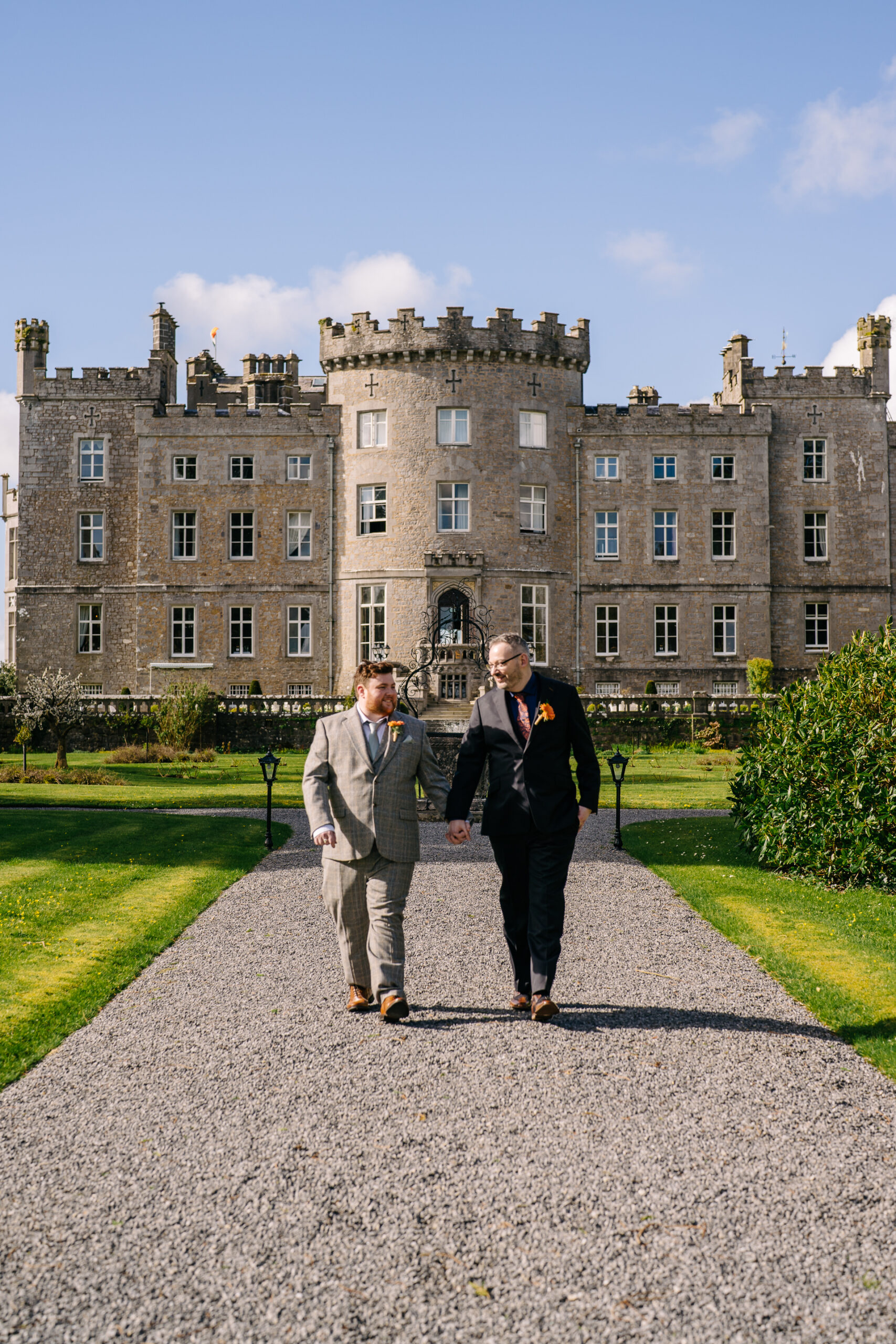 Two grooms posing for romantic wedding portraits in the gardens of Markree Castle