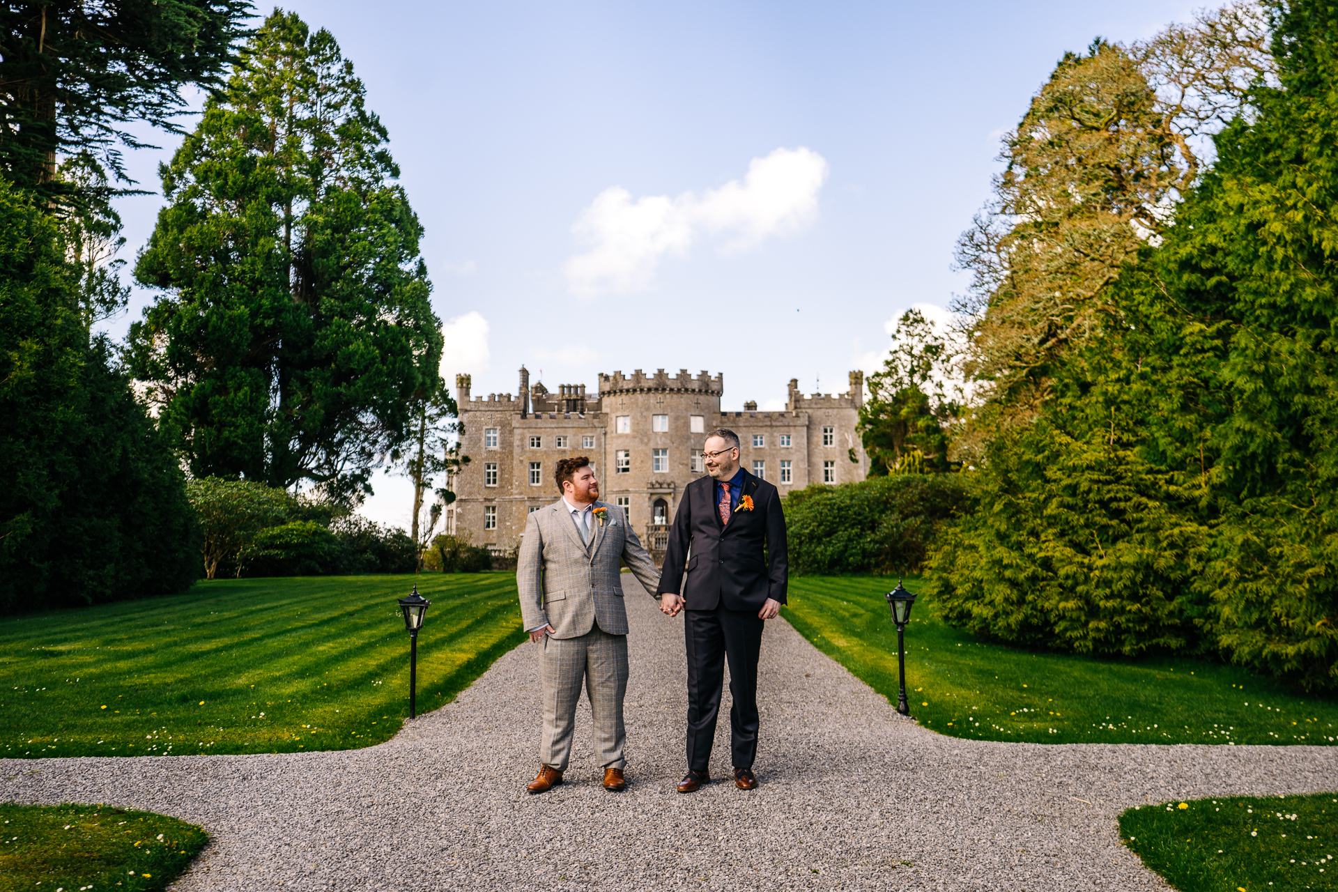 Two grooms posing for romantic wedding portraits in the gardens of Markree Castle