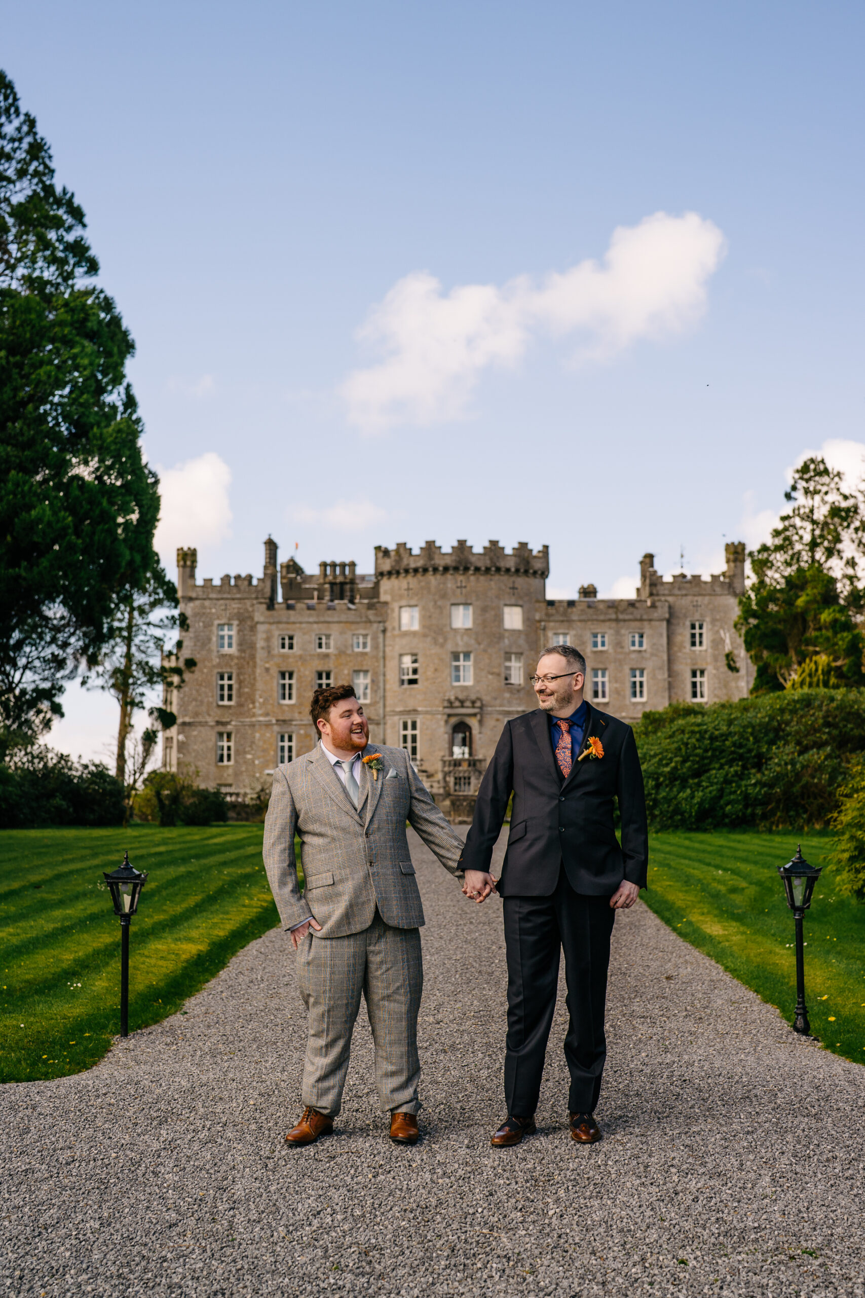 Two grooms posing for romantic wedding portraits in the gardens of Markree Castle