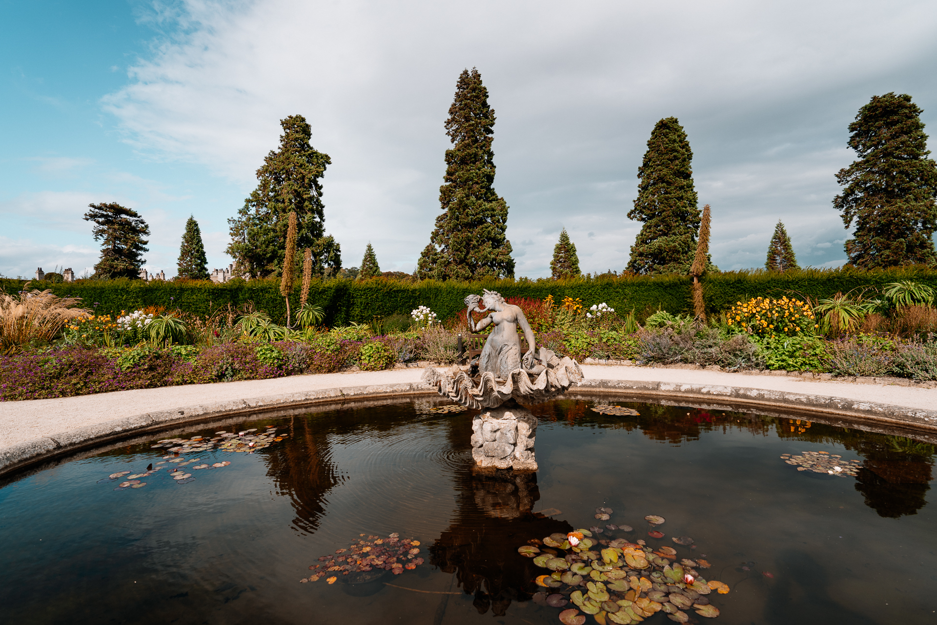 A pond with a statue in it