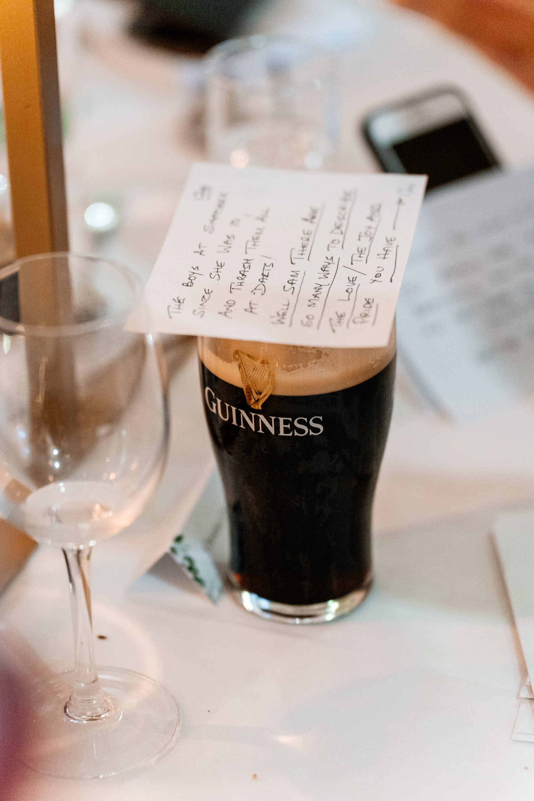 A glass of beer next to a bottle of beer