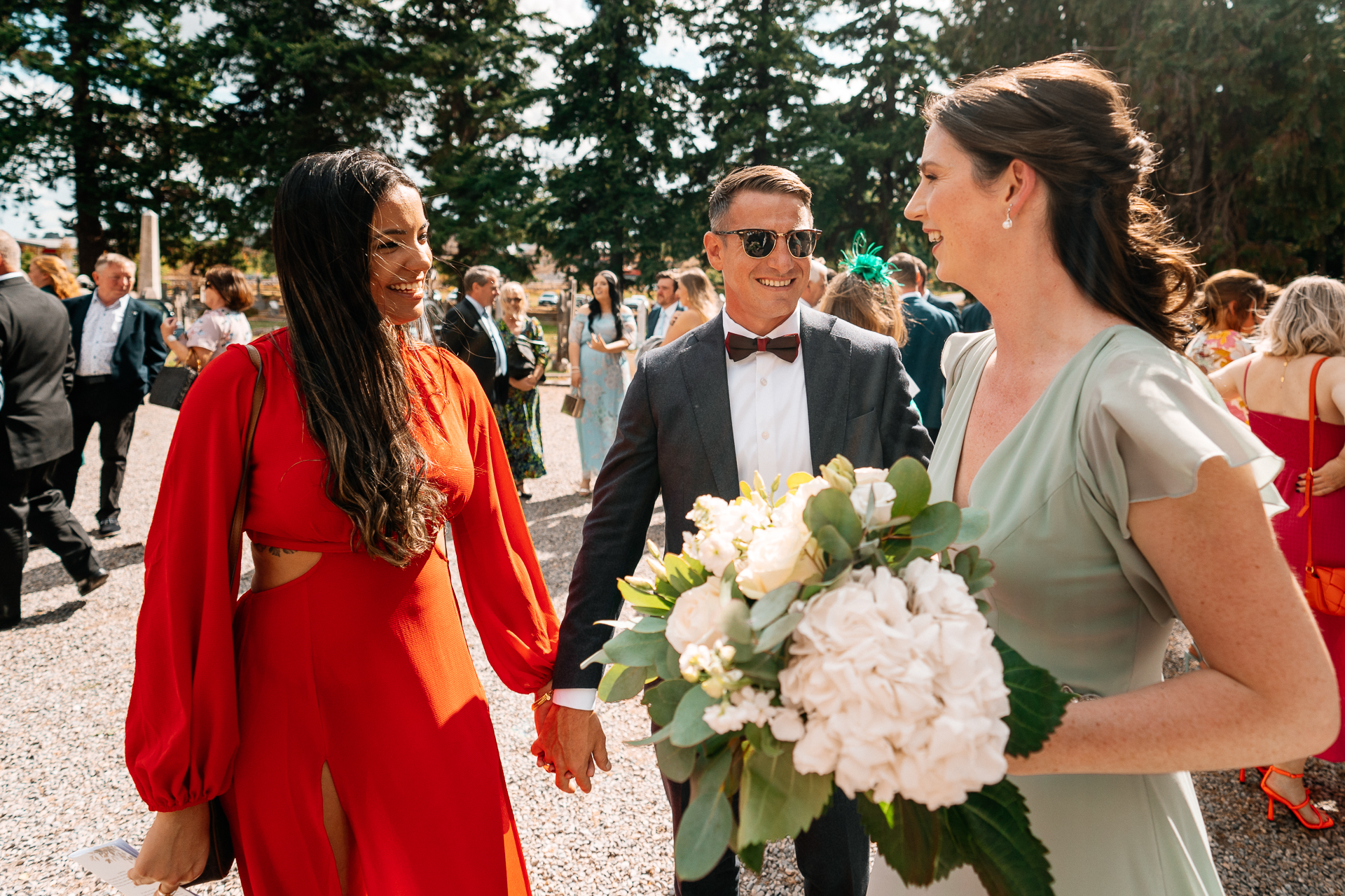 A man in a suit holding a bouquet of flowers with a woman in a dress