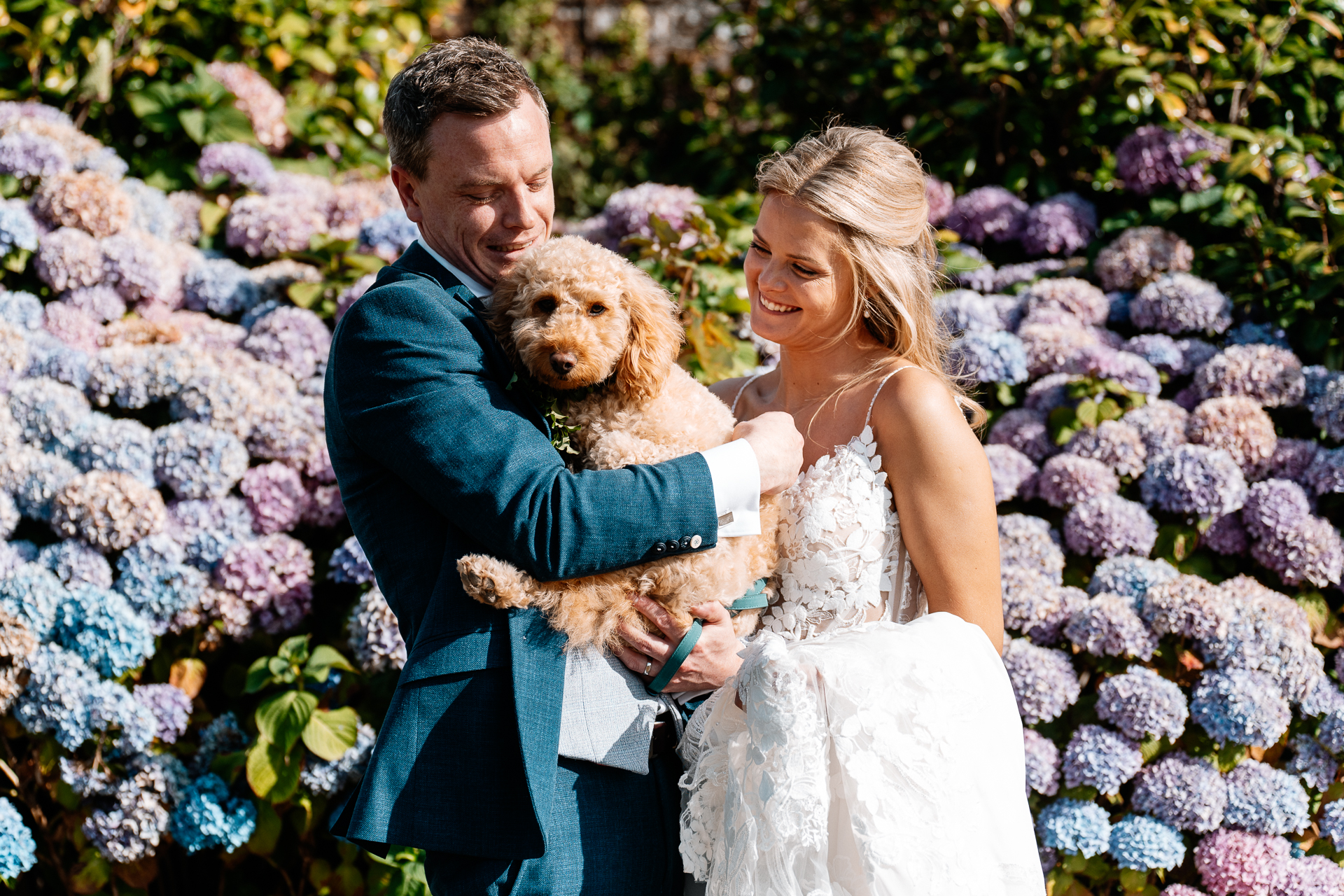 A man and woman holding a dog