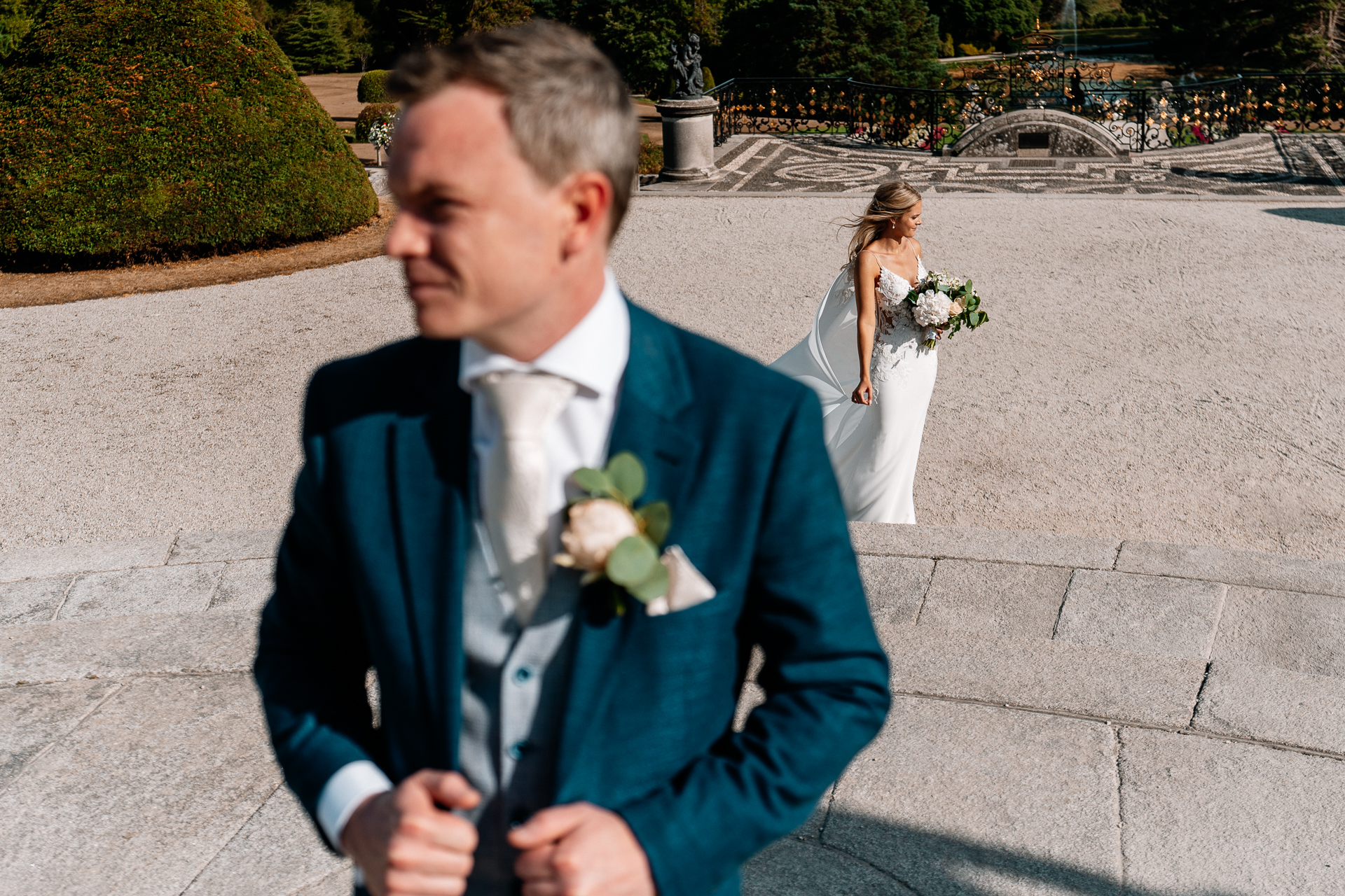 A person in a suit and tie holding a bouquet of flowers