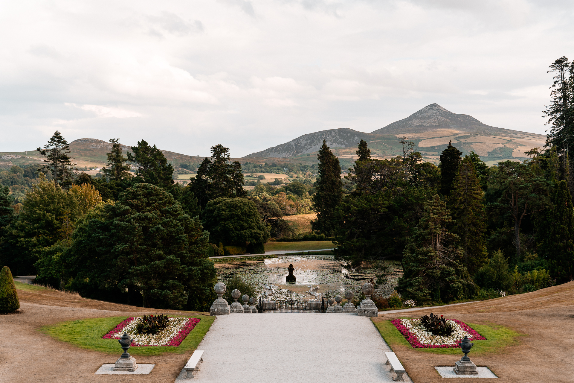 Bride getting ready at Powerscourt House, Wicklow, with her bridesmaids assisting in a luxurious suite.