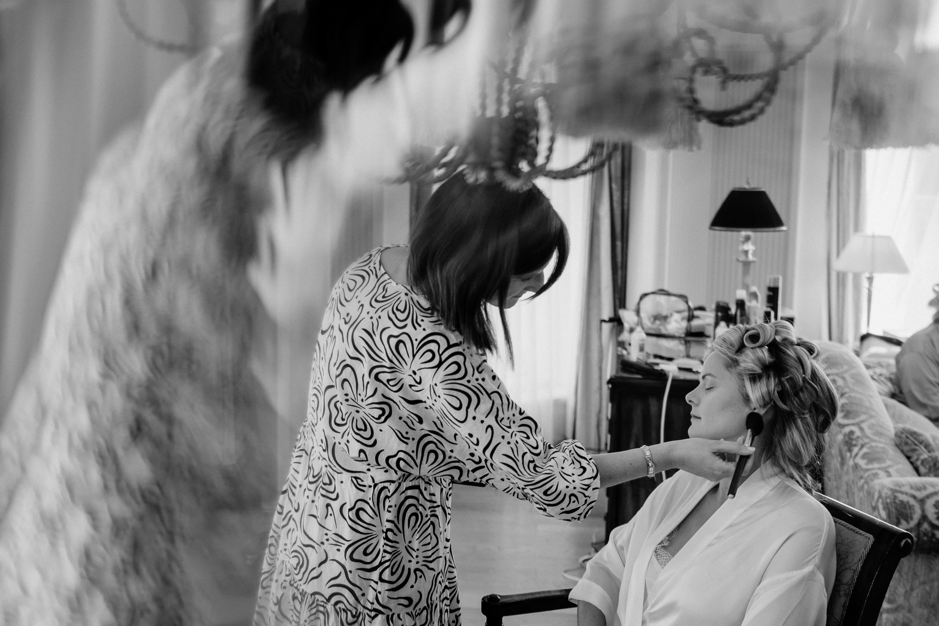 Bride getting ready at Powerscourt House, Wicklow, with her bridesmaids assisting in a luxurious suite.