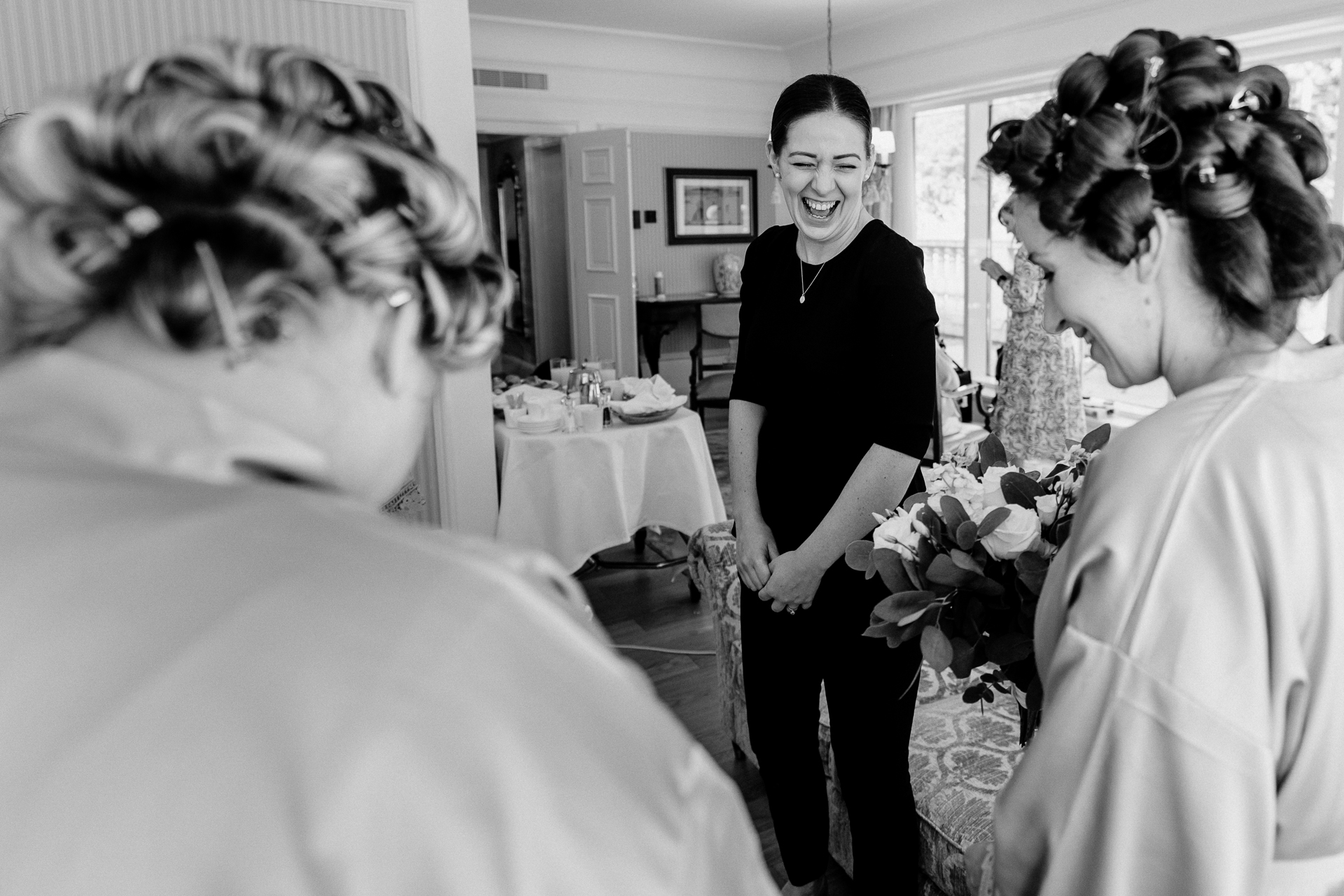 Bride getting ready at Powerscourt House, Wicklow, with her bridesmaids assisting in a luxurious suite.