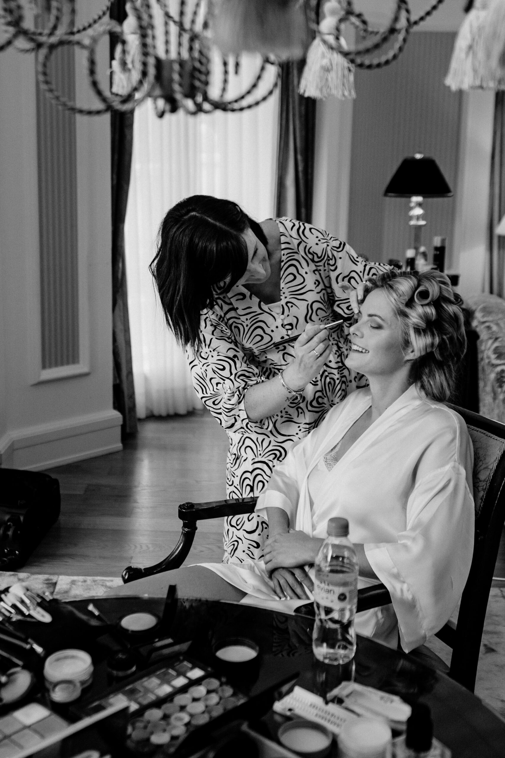 Bride getting ready at Powerscourt House, Wicklow, with her bridesmaids assisting in a luxurious suite.